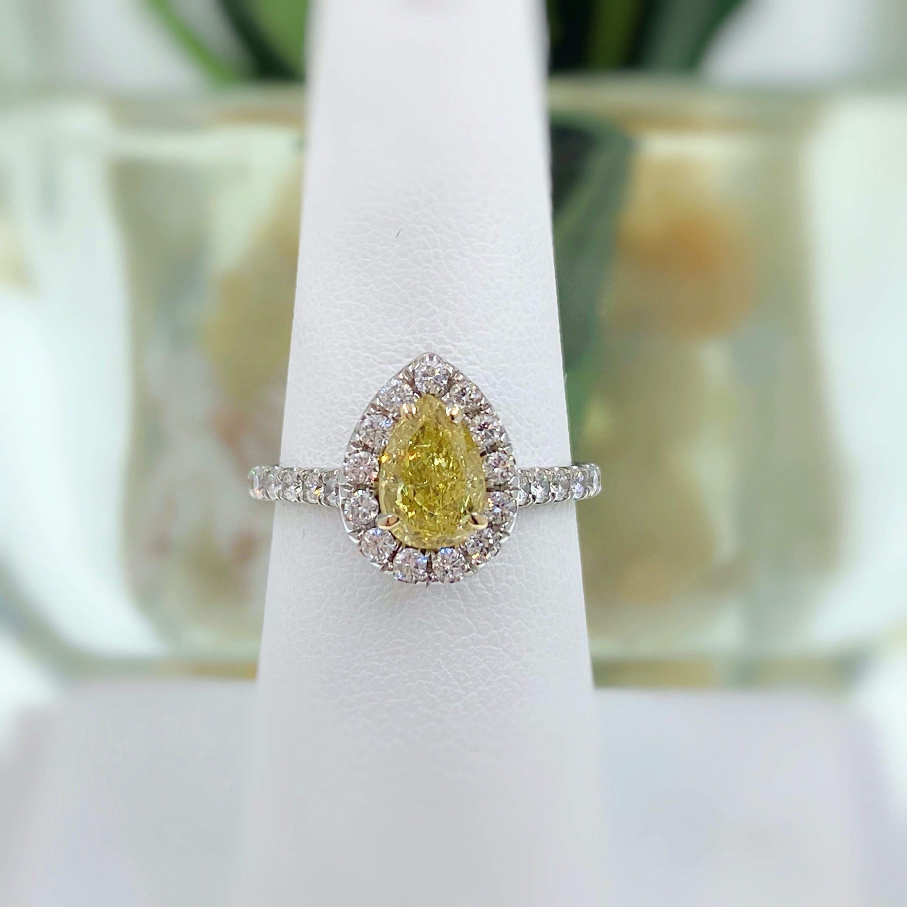 Fancy Intense Yellow Diamond Halo Engagement Ring

Style:  Custom made halo design with diamonds set halfway down sides of the ring
Metal: 14K white gold
TCW:  1.60 tcw
Main Diamond:  1.00 carat Pear Shape, measures 7.79 x 5.37 x 3.18 mm
Color &