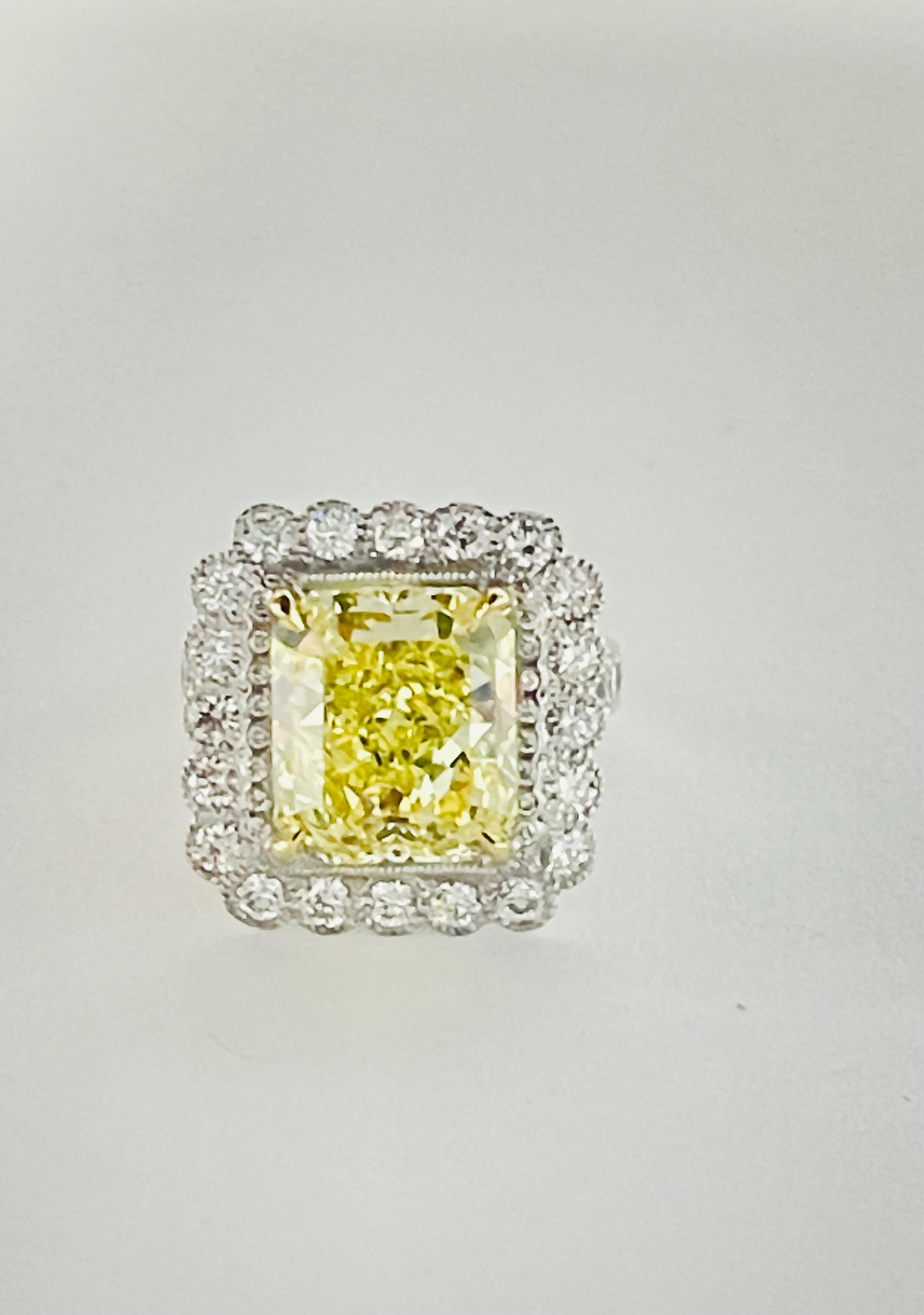 Absolutely Gorgeous Fancy intense yellow radiant  diamond ( looks like vivid yellow in person ) and white diamond ring beautifully hand crafted in platinum. 

The details are as follows : 

Fancy Intense Yellow Radiant Diamond weight : 7.58 carat