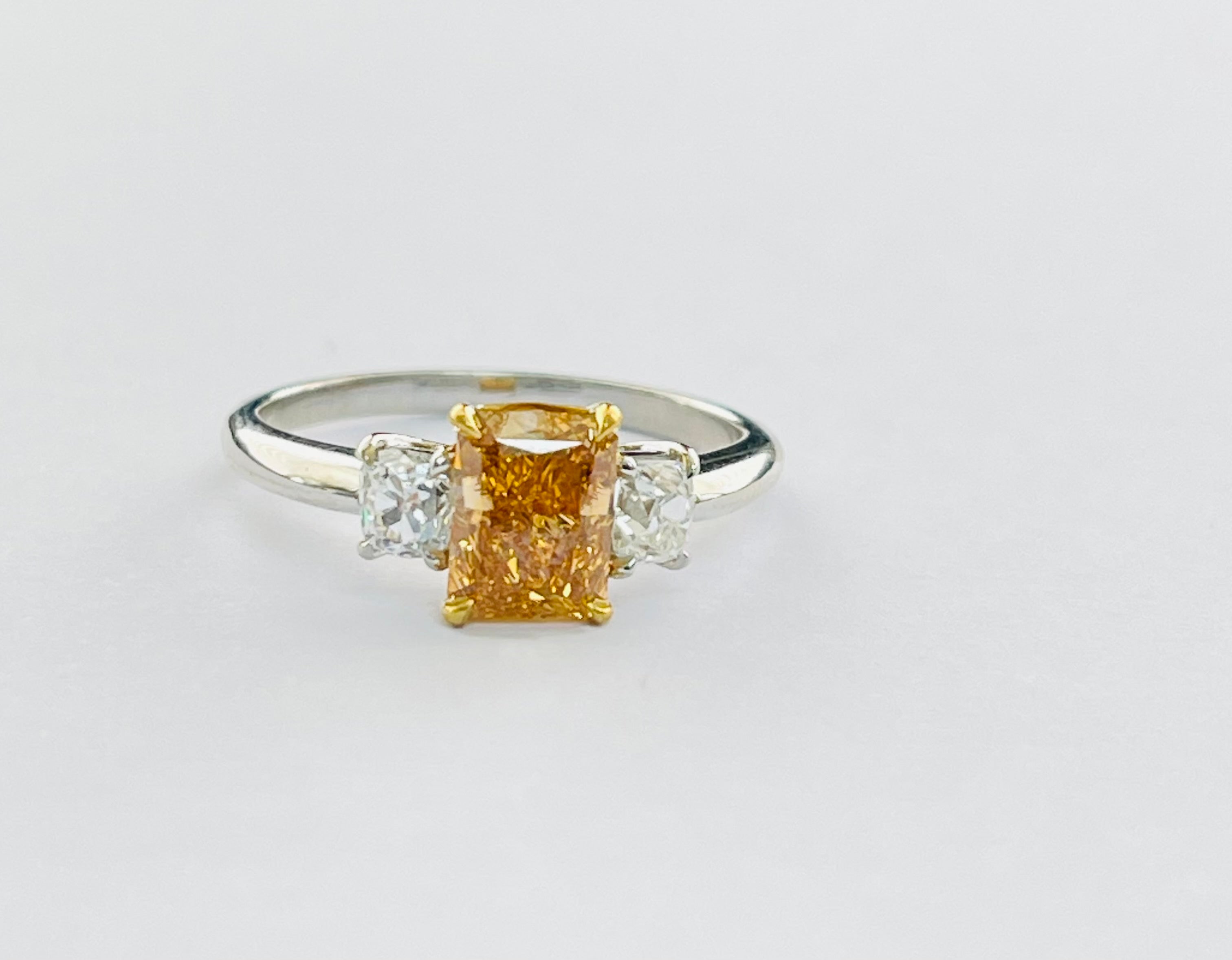 Fancy Intense Yellowish Orange engagement ring beautifully handmade in 22 karat gold and platinum. 

The details are as follows : 

Fancy intense yellowish orange : 1.25 carat 
Clarity : VS2 
Old cut diamond weight : 0.53 carat /2 with G color and