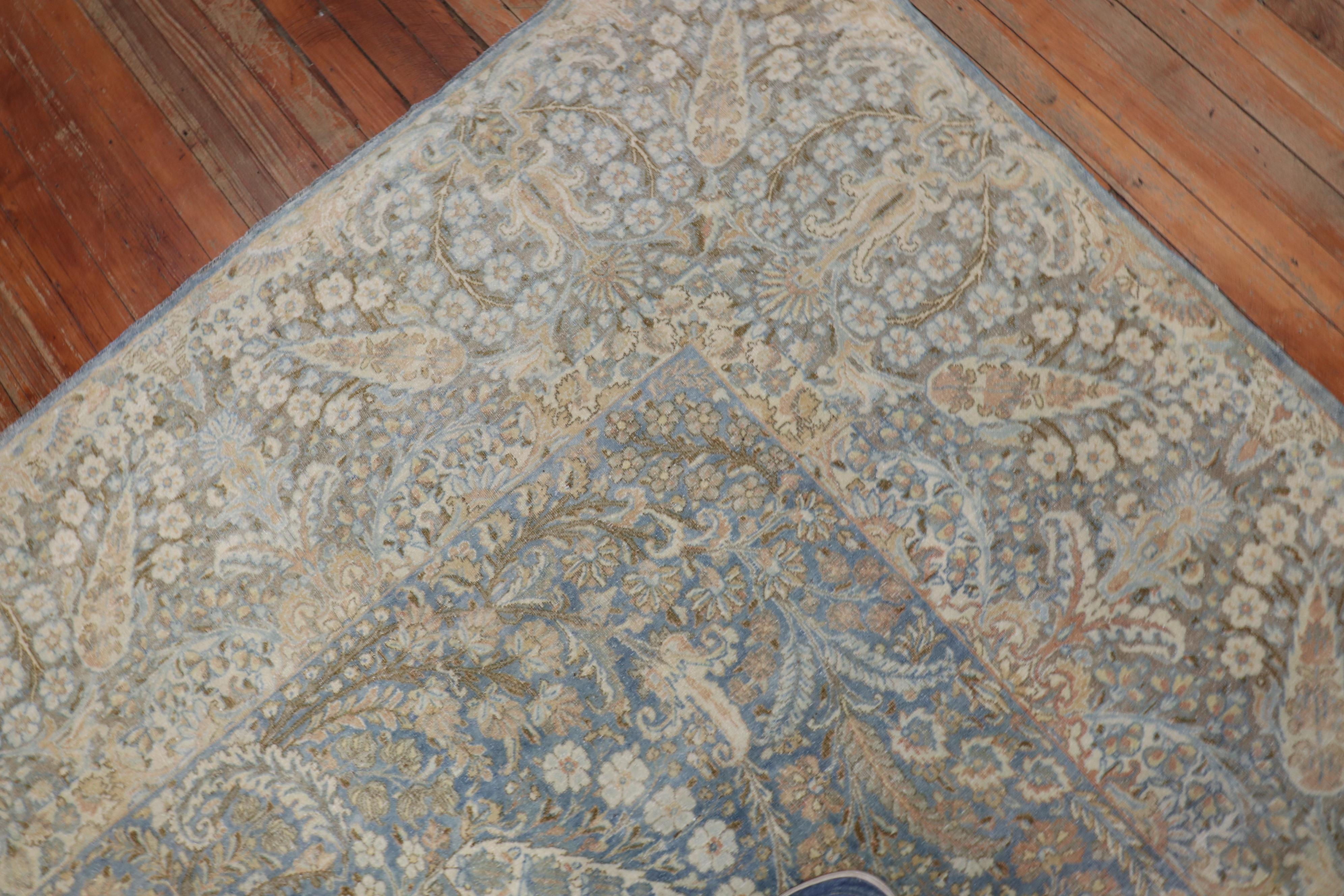 A room size handmade Persian Kerman rug with sand and brown accents on a light blue field

circa 1920. Measures: 8'9