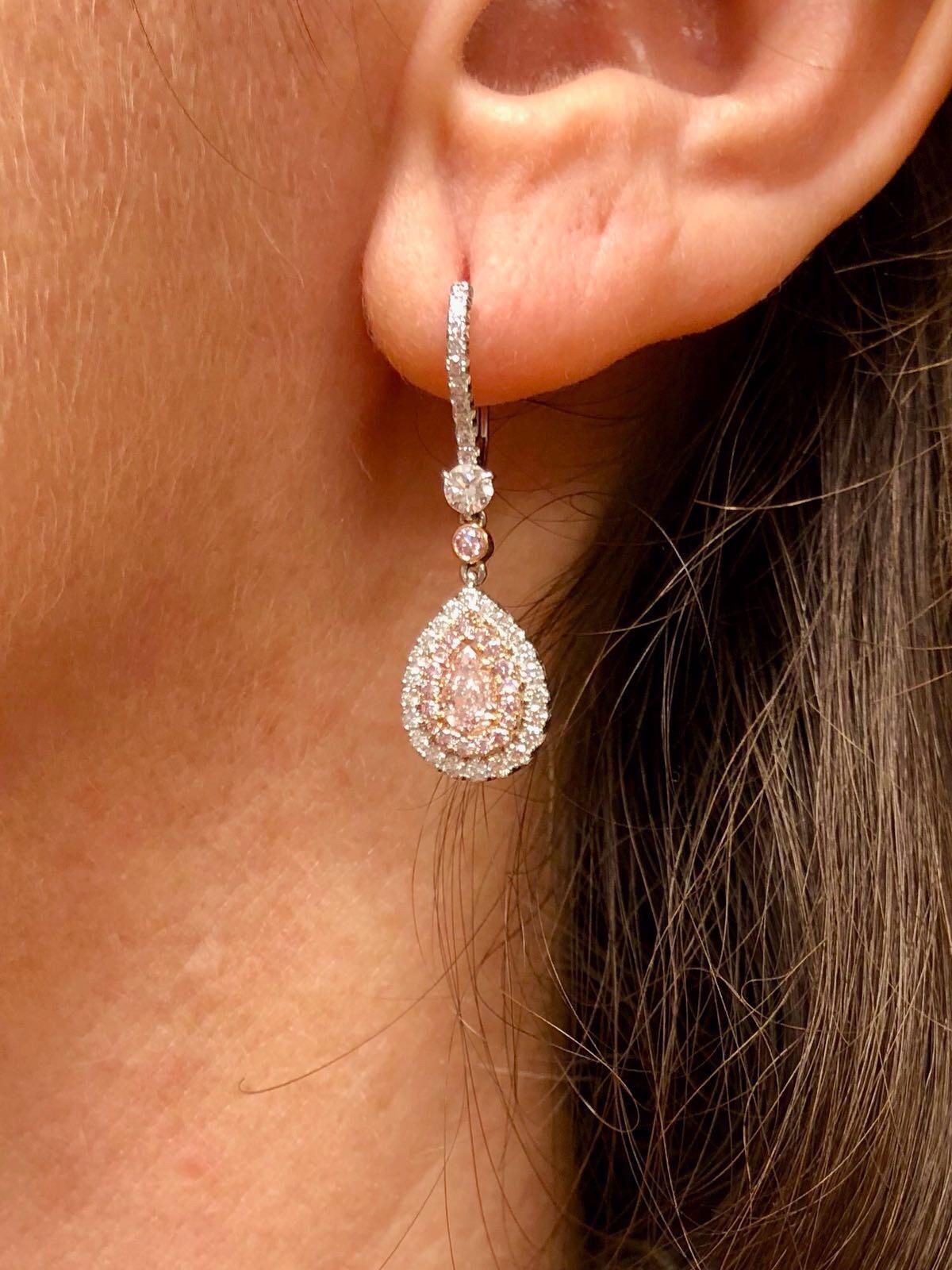 Pink Diamond earrings for women, unveiling a romantic pair of Fancy Light Pink diamond pear shapes (0.26ct and 0.27ct), weighing a total of 0.53ct, surrounded by a total of 0.28ct fancy pink round brilliant diamonds, and 0.49ct total F color and VS