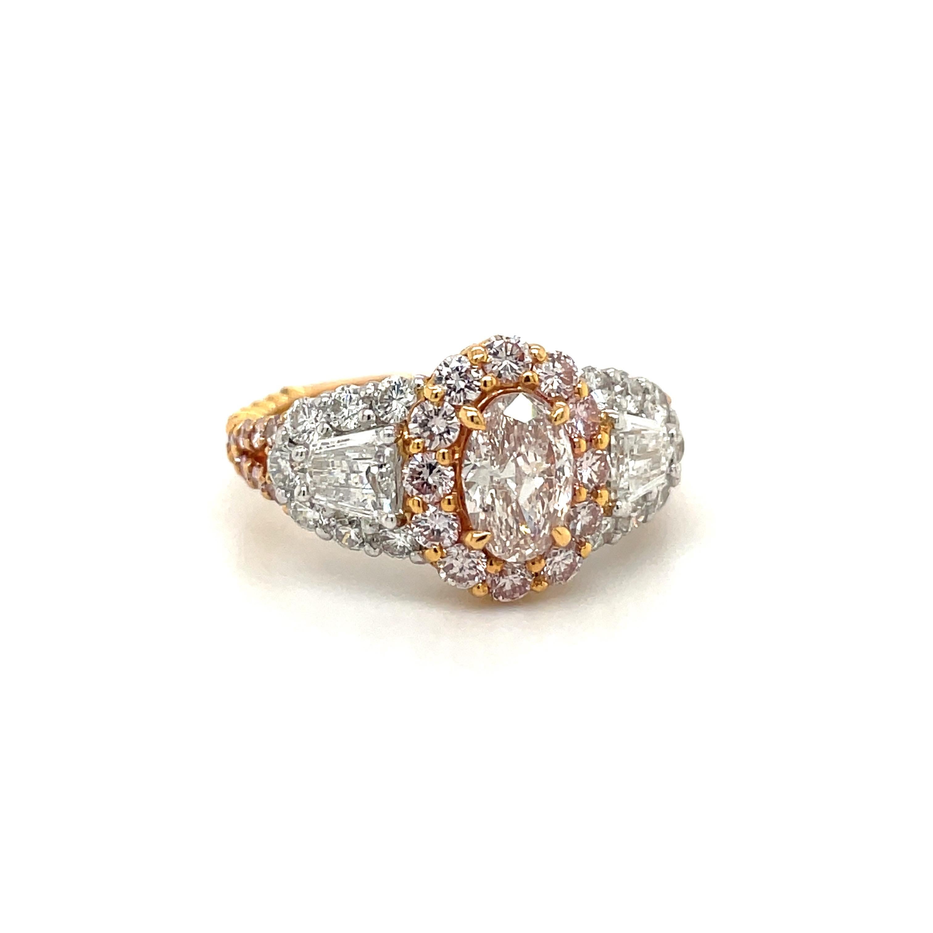 Created by Cellini Jewelers, this stunning oval-cut fancy light brownish pink is set in a truly unique 18-karat rose gold and platinum, surrounded by round brilliant pink diamonds and accented with white diamonds.
Center oval- cut pink diamond