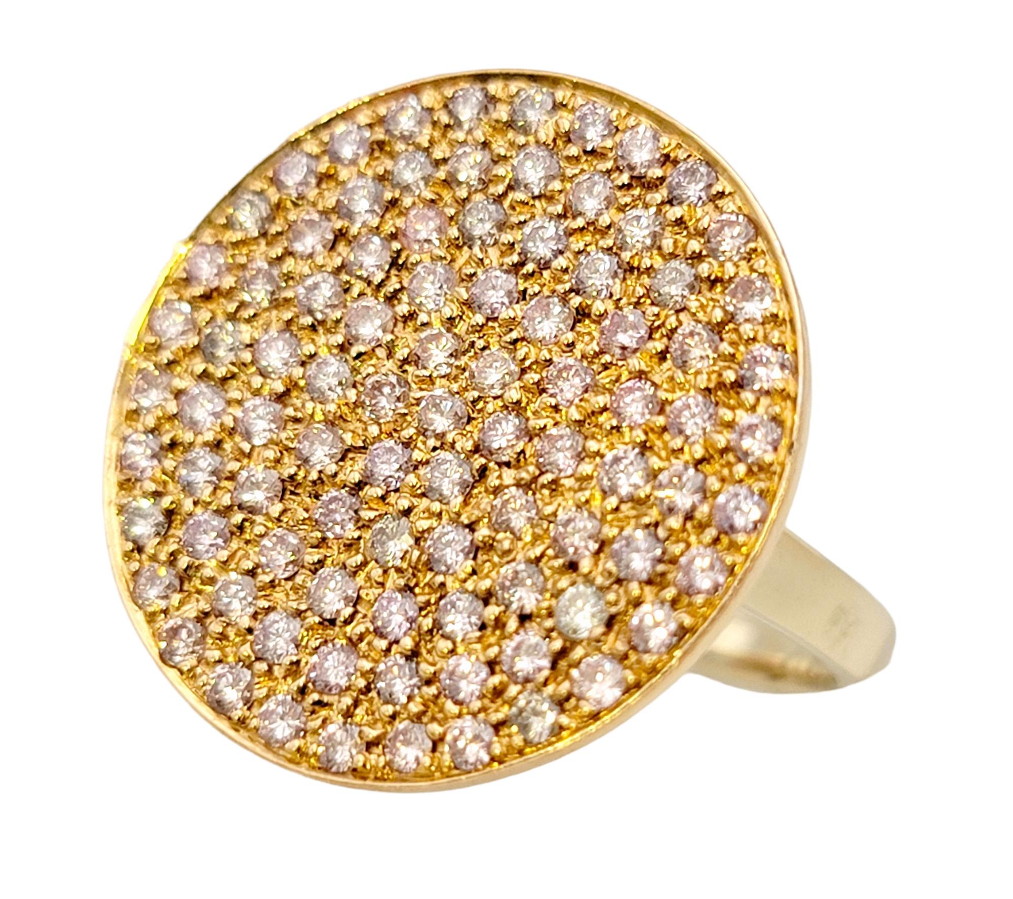 Ring size: 7.5

This bright, beautiful pink diamond disc ring is absolutely bursting with sparkle! Featuring 91 natural fancy light pink pave set diamonds in a large circular setting, this multi-tone gold ring really fills the finger with dazzling