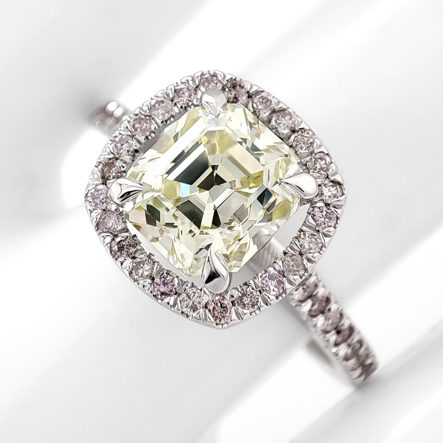 This exquisite ring features a 1.90-carat natural octagon step-cut diamond in Fancy Light Yellow, surrounded by 42 round brilliant cut diamonds totaling 0.35 carats in Faint Pink to Fancy Pink hues. Crafted in 14-karat white gold (stamped 585) and