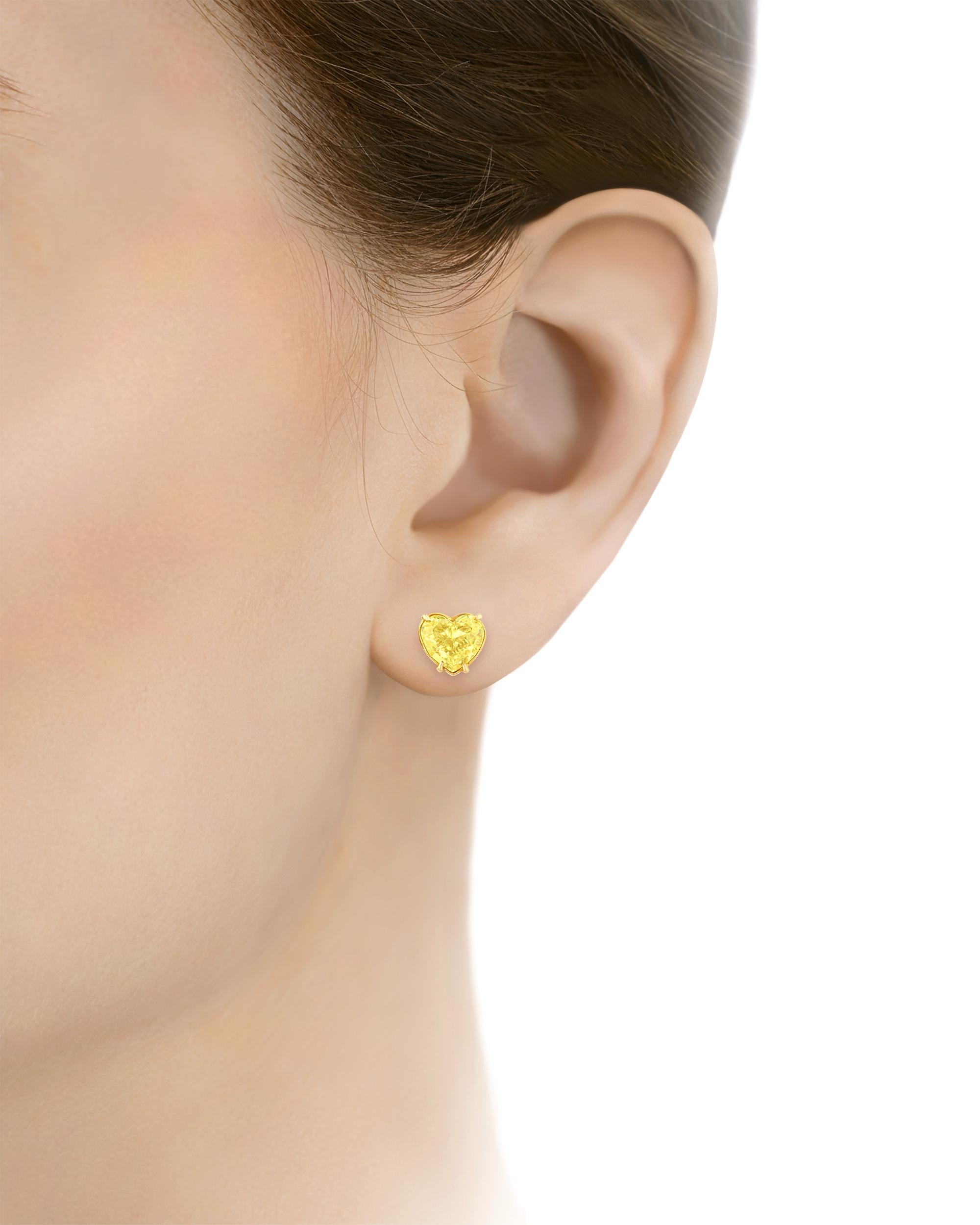 This exquisite pair of earrings features two superb fancy light yellow diamonds faceted into enchanting heart shapes. These earrings marry exquisite rarity with refined design. Showcasing even color distribution and totaling 4.21 carats, these fancy