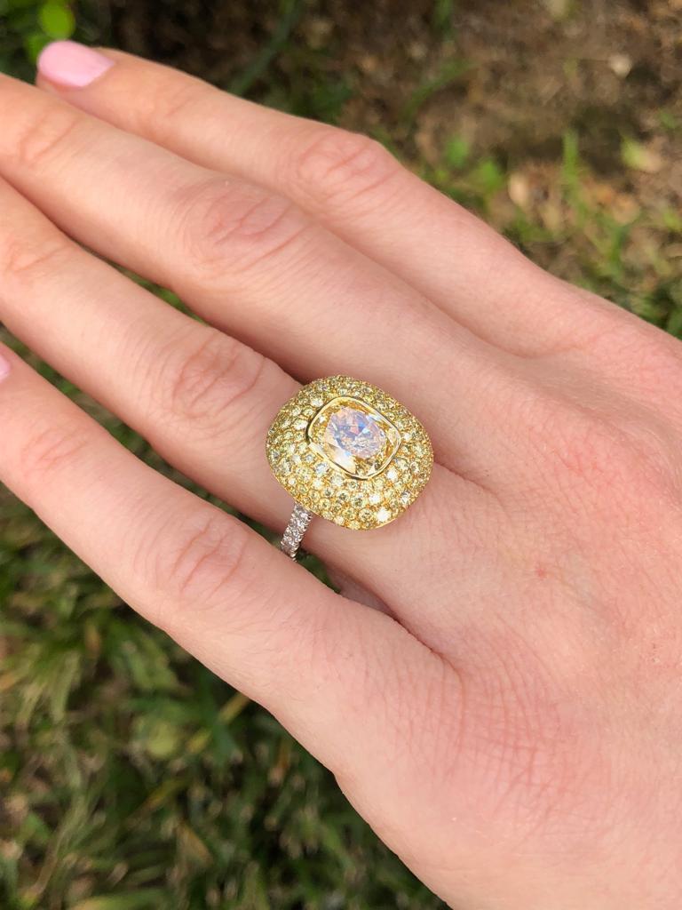 Notable 3.01 carat cushion cut, Fancy Light Yellow diamond, VS1 clarity,  surrounded by an array of 1.41 carat total round brilliant Fancy Yellow Diamonds, and accented by a total of 0.41 carat round brilliant, F-G color, VS clarity diamonds, set