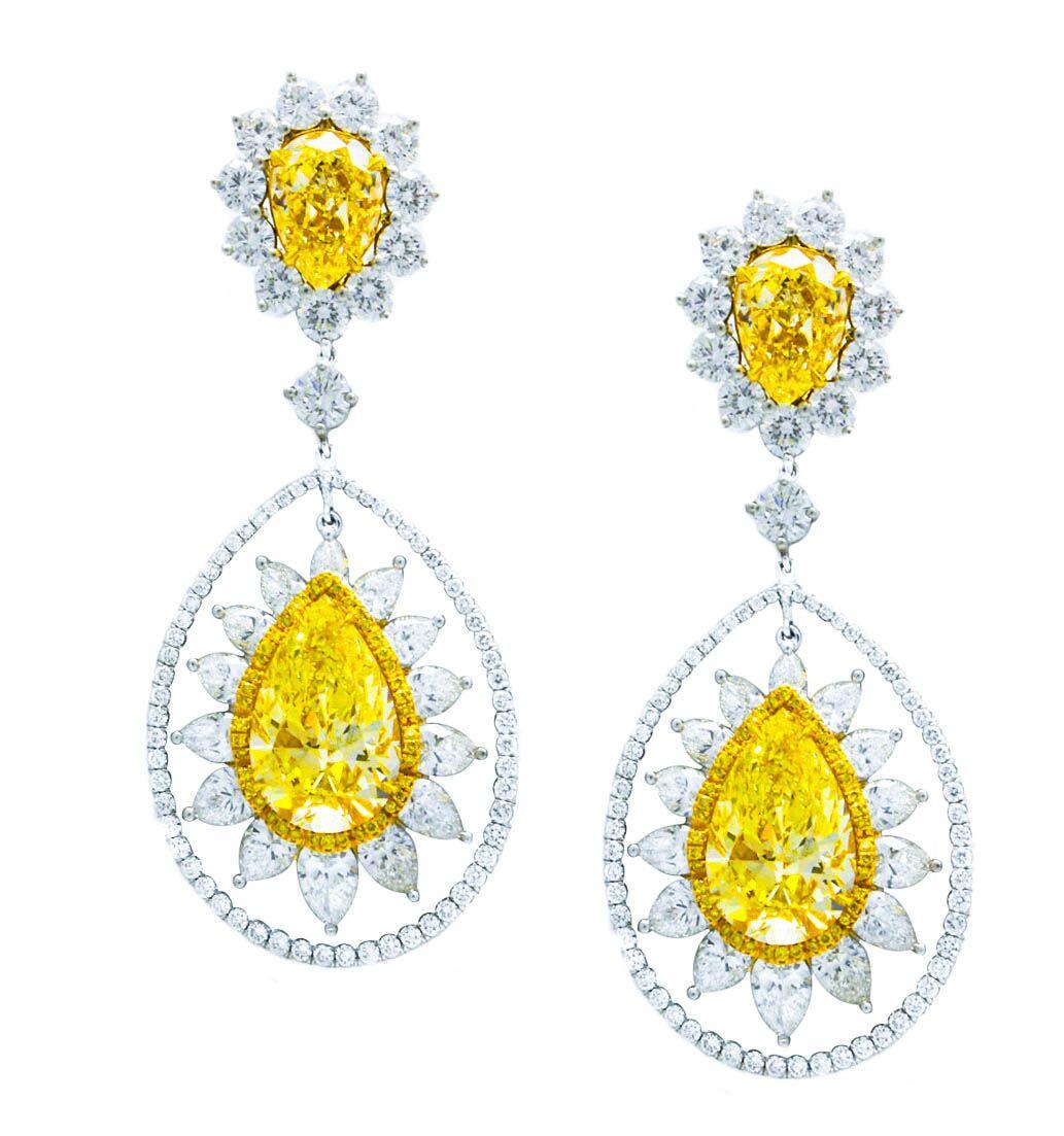 11.40 cts of fancy light yellow stones surrounded by 8.00cts of pear and round shape white diamonds 

