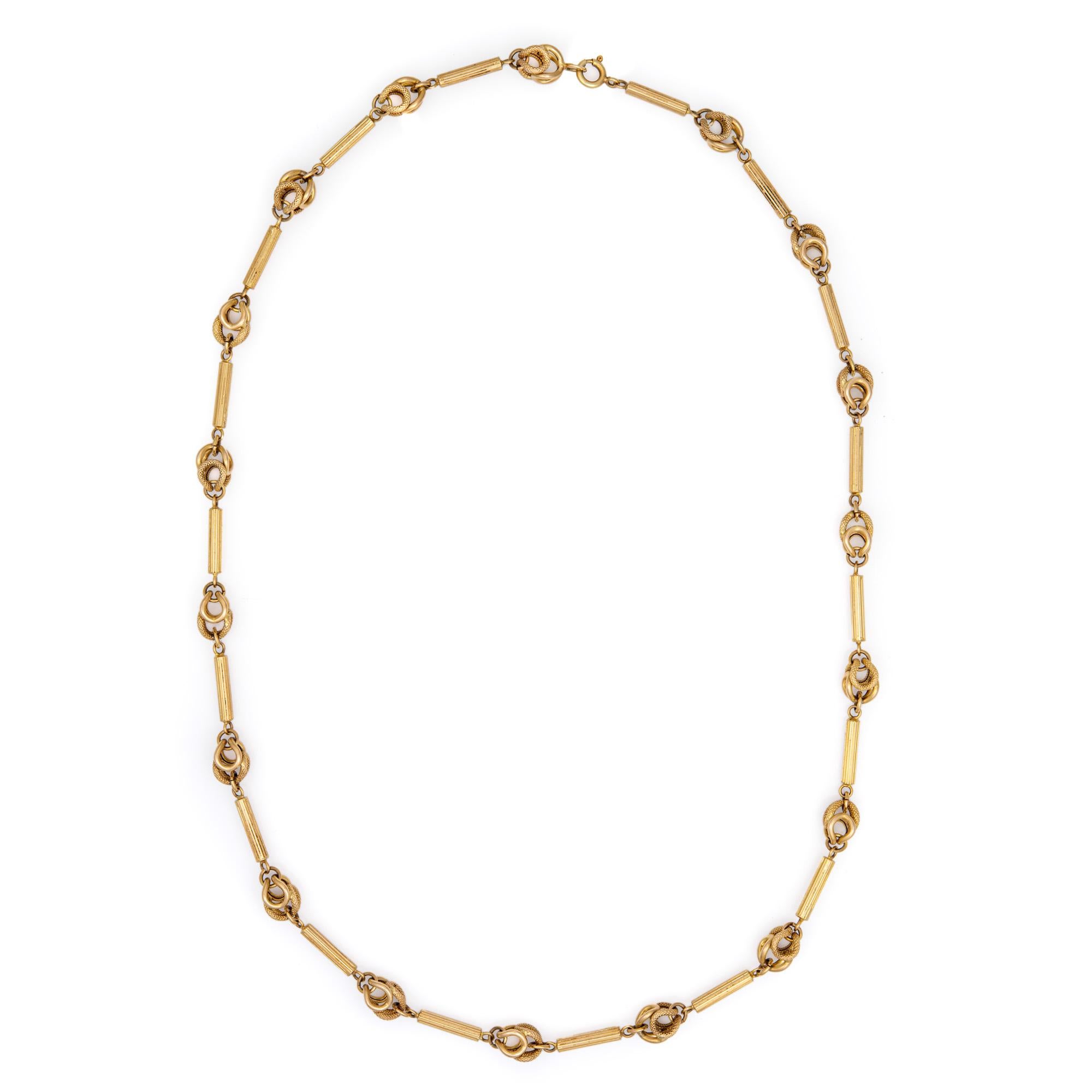 Finely detailed fancy link necklace crafted in 14 karat yellow gold (circa 1960s to 1970s). 

The stylish necklace features a scrolled design, closely joined together with high polished and textured gold links for maximum effect. The necklace weighs