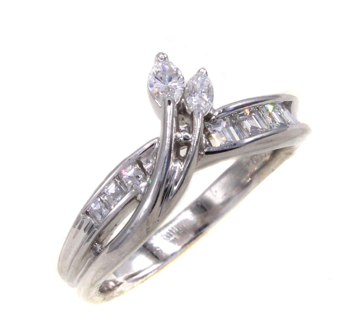 Beautifully designed and masterfully handcrafted this platinum ring has 2 bright white marquis diamonds extending over this band embellished channel set baguette cut diamonds on either side. The total diamond weight is 0.48 carats. Ring size 5, can