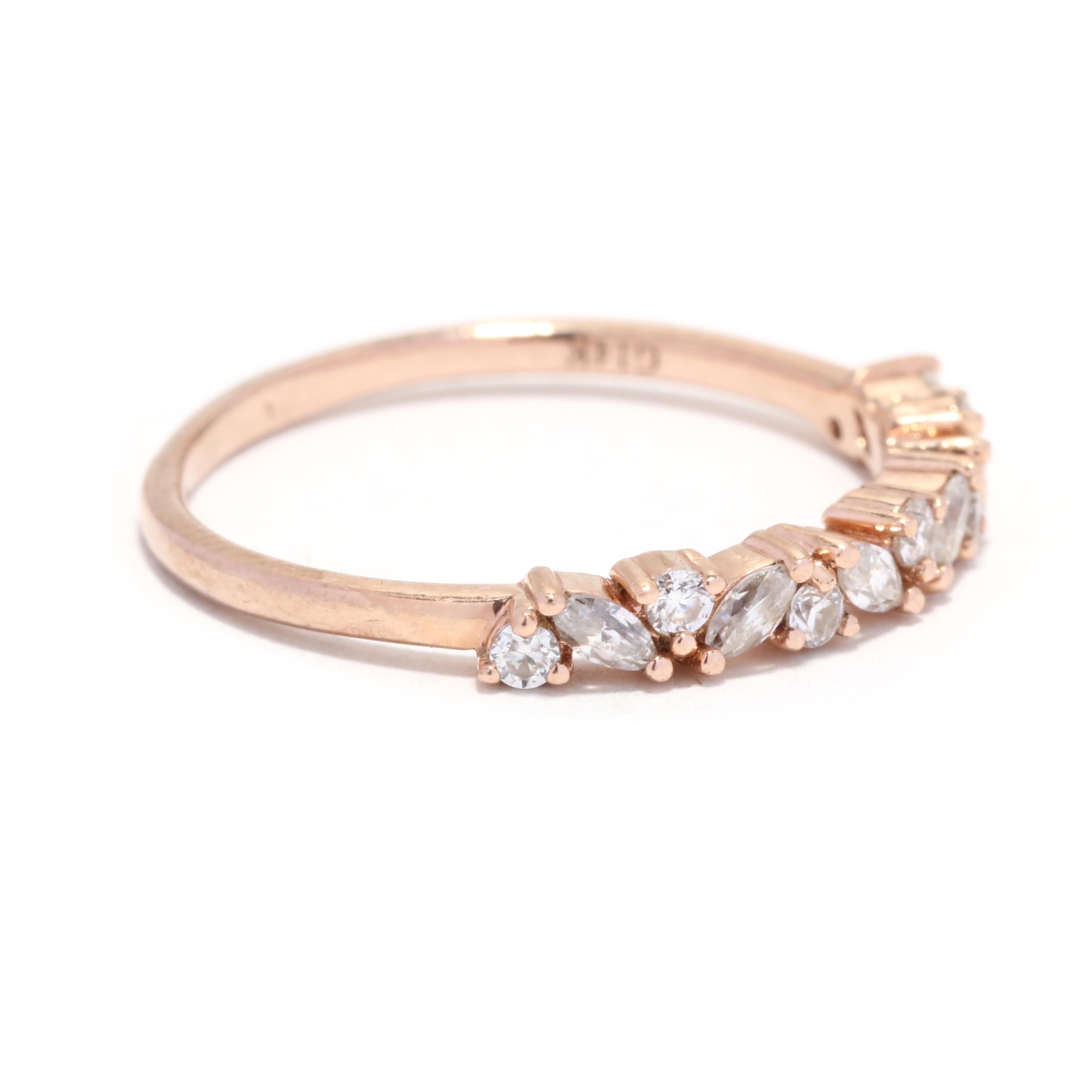 A 14 karat rose gold fancy moissanite wedding band. This stackable moissanite band features alternating marquise and round brilliant cut moissanite stones weighing approximately .25 total carats (diamond equivalent) and with a slightly tapered