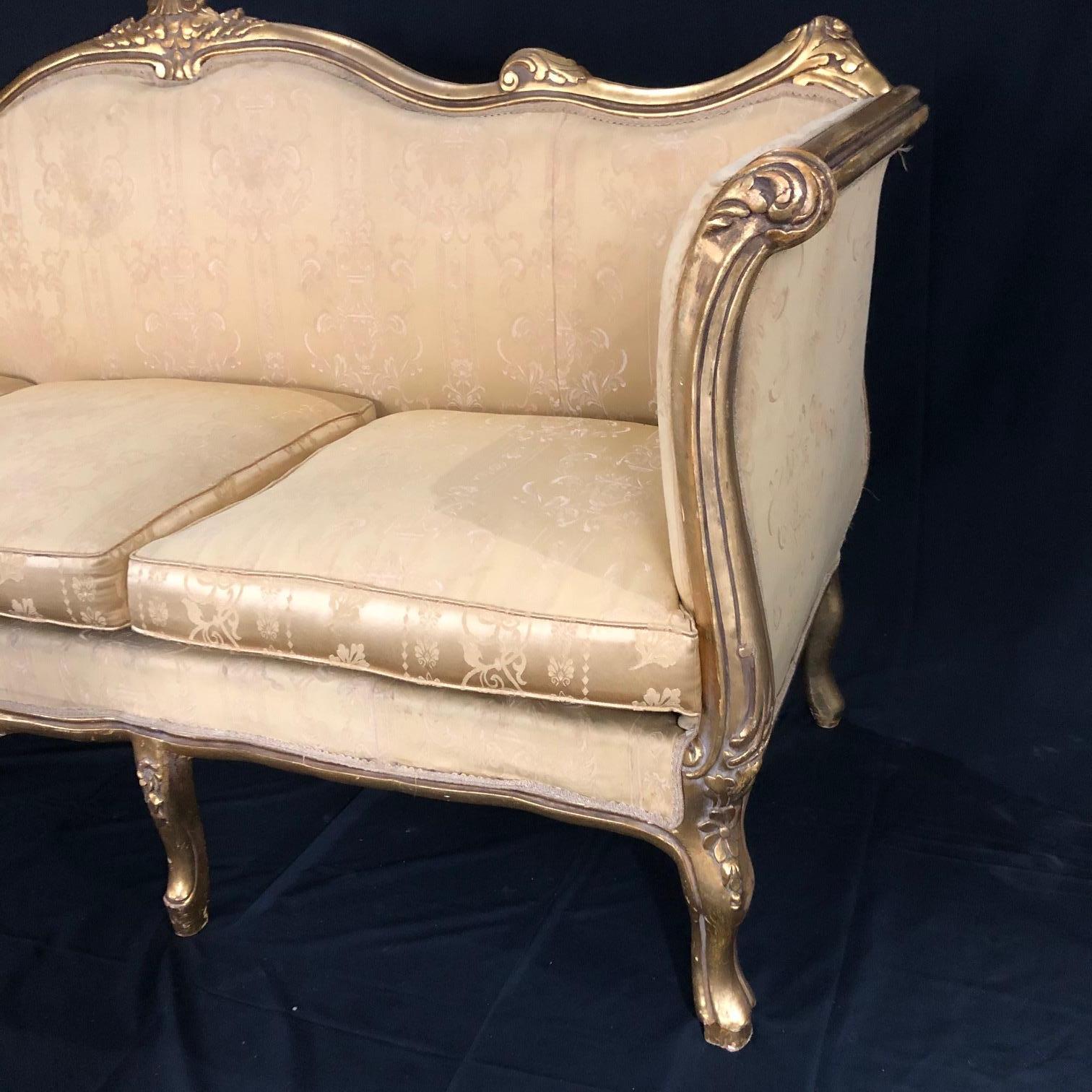 French Louis XV sofa having richly carved and gilded wood and original gold silk blend upholstery in very good condition (see photos). Classic, solid and quite comfortable. Very glamorous. #5148
Measures: Arm height 36
Seat height 21.