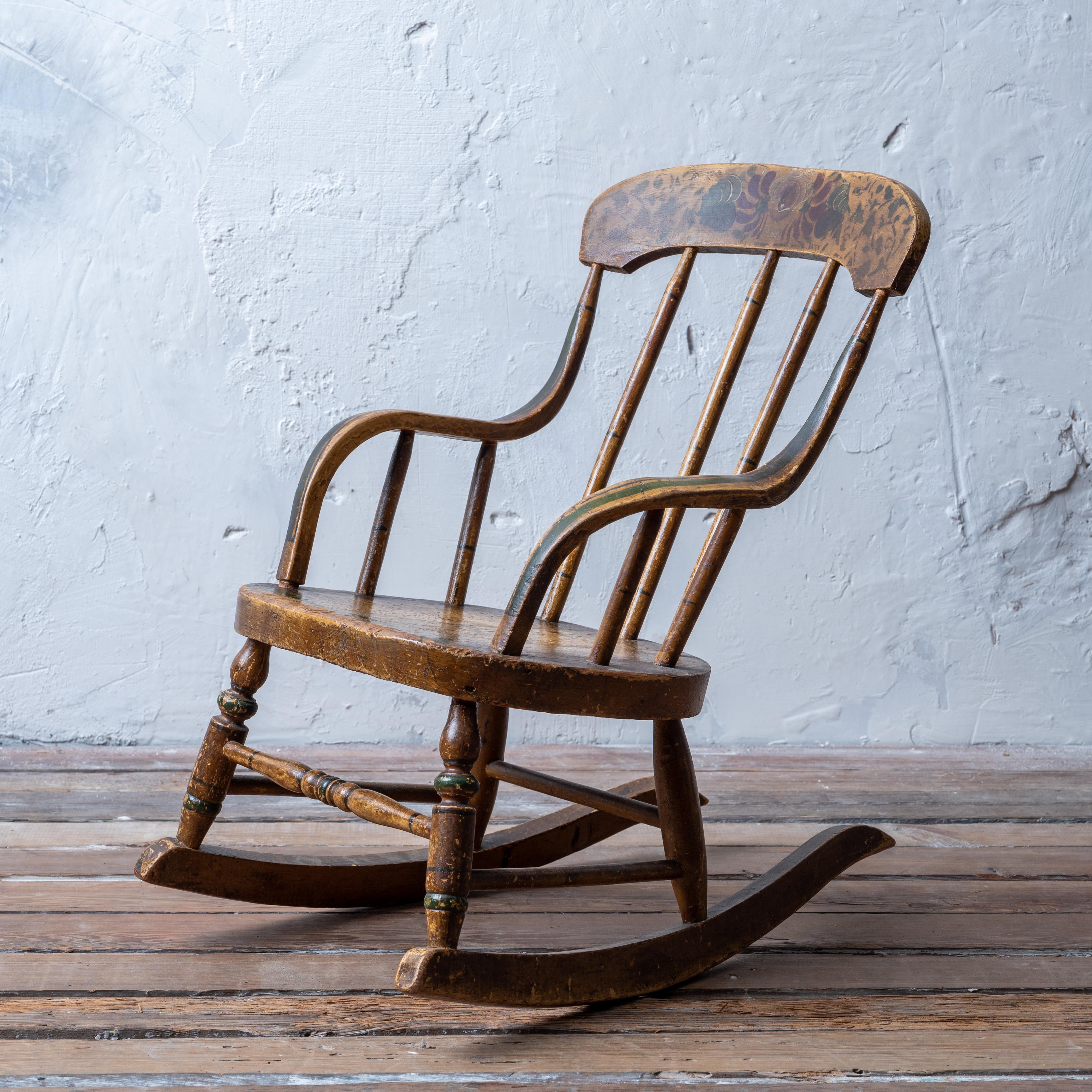 Fancy Painted Child’s Rocking Chair, mid-19th century.

14 inches wide by 18 ½ inches deep by 21 ¾ inches tall
