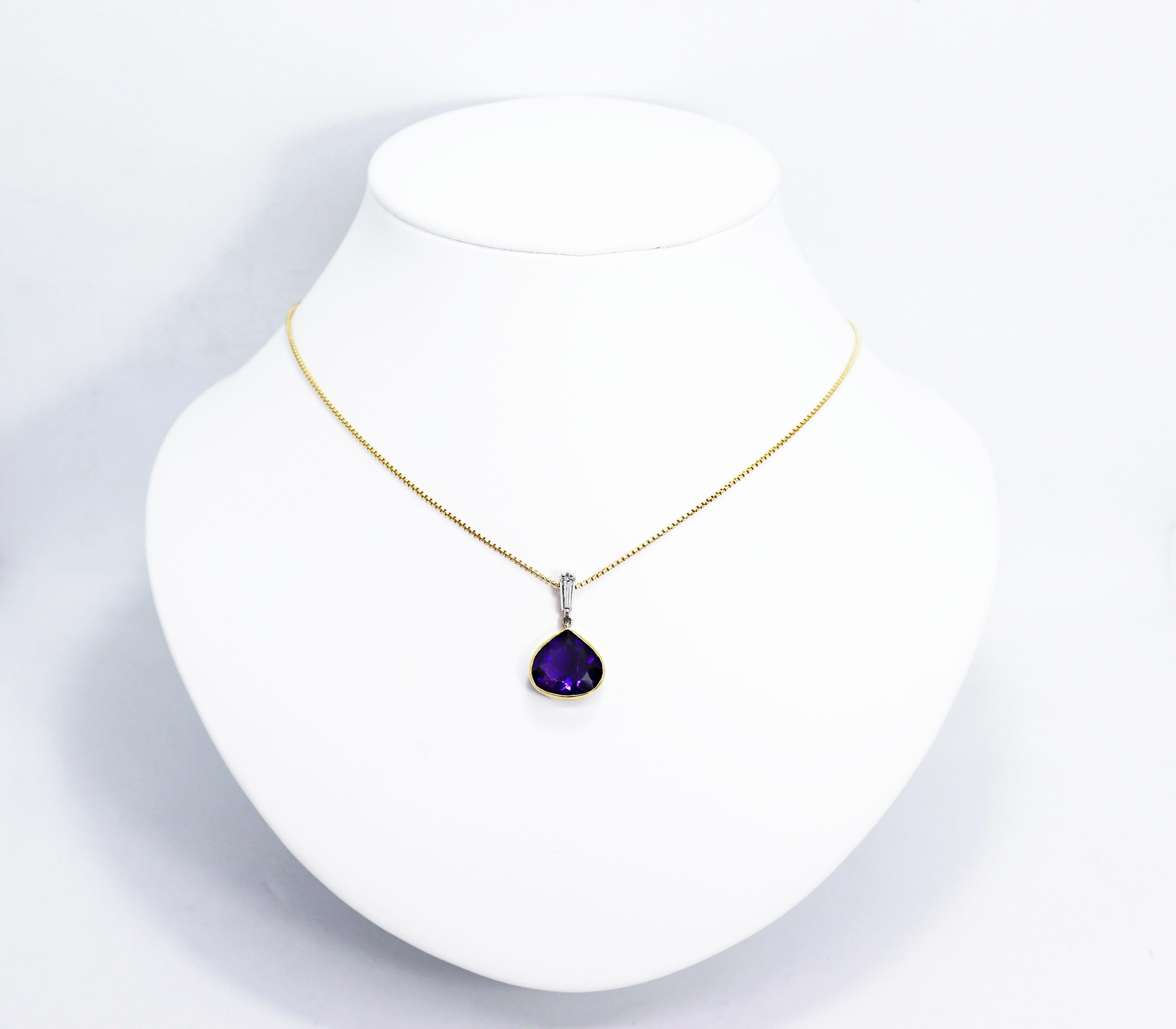 Beautiful pendant set with a fine quality fancy pear shaped amethyst weighing 5.15ct in an 18 carat yellow gold rub-over open back setting. The amethyst is linked to a tapered baguette cut diamond above it weighing 0.29ct in an 18 carat white gold
