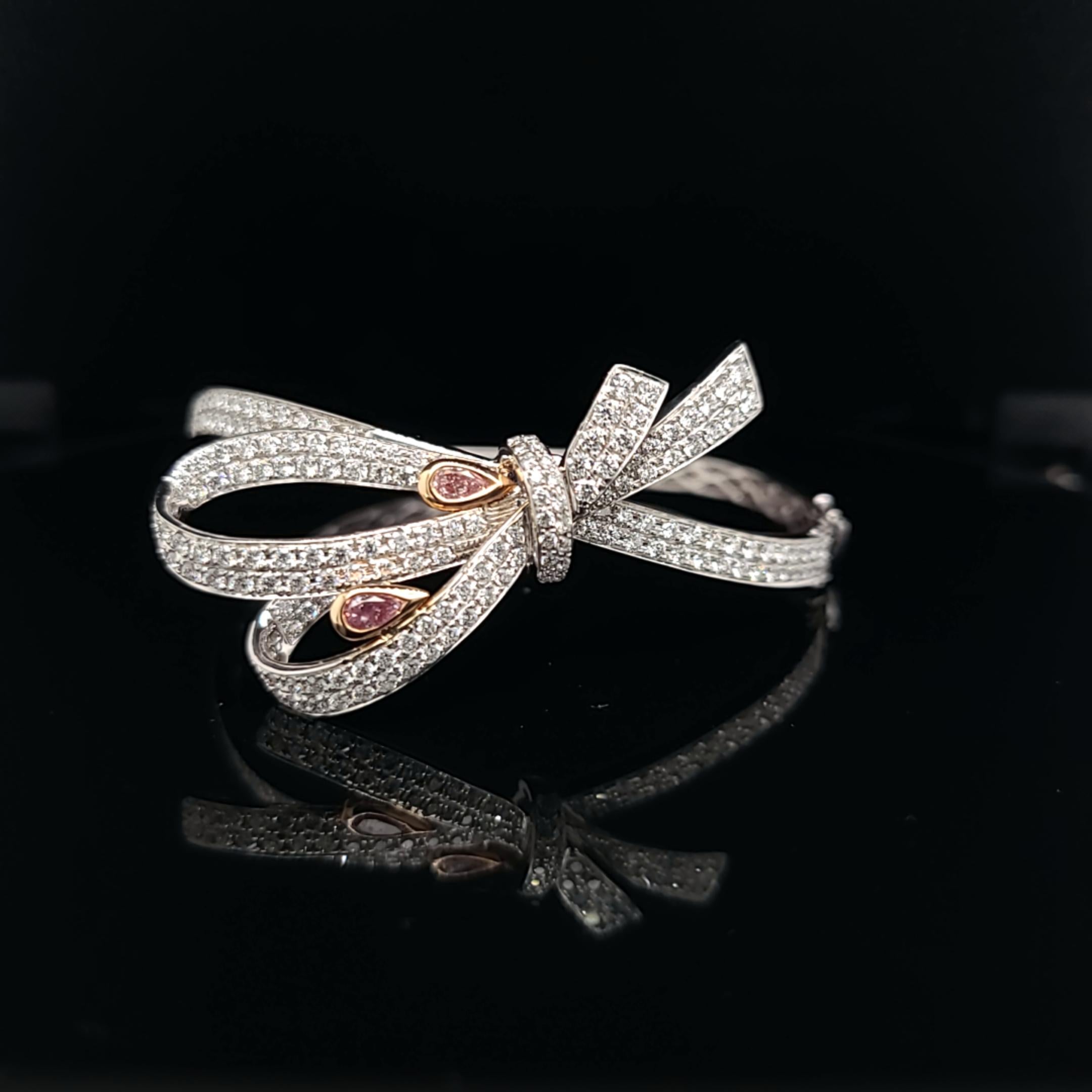 Bow bracelet featuring 0.46 carats of pink diamonds and 2.80 carats white diamonds set in 18k rose and white gold. 