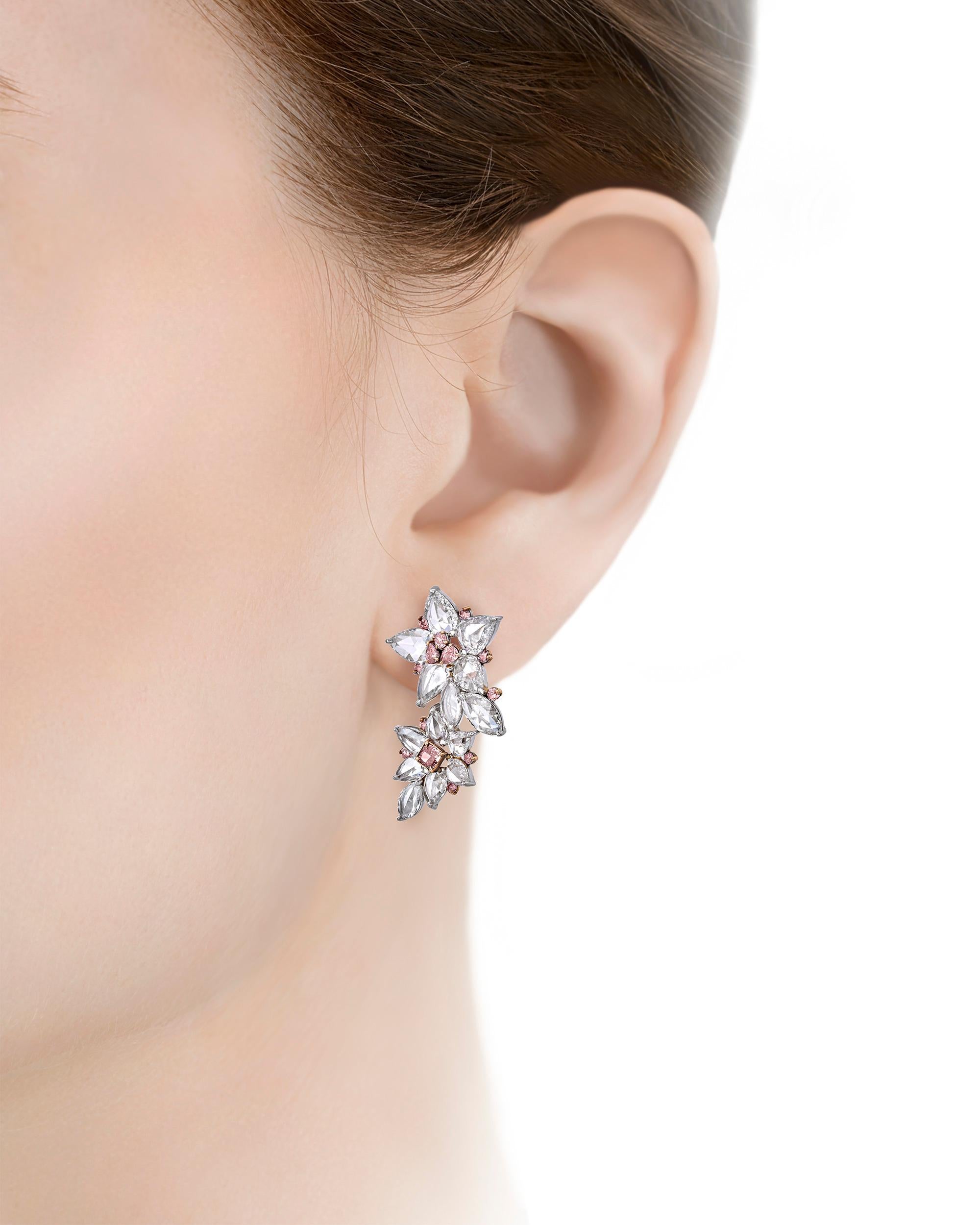 Twenty-six exceptionally rare fancy pink diamonds totaling 1.19 carats take center stage in these floral earrings. The rosy gems include two fancy intense pink diamonds set in the center of each bottom bloom weighing 0.16 and 0.20 carat. These two