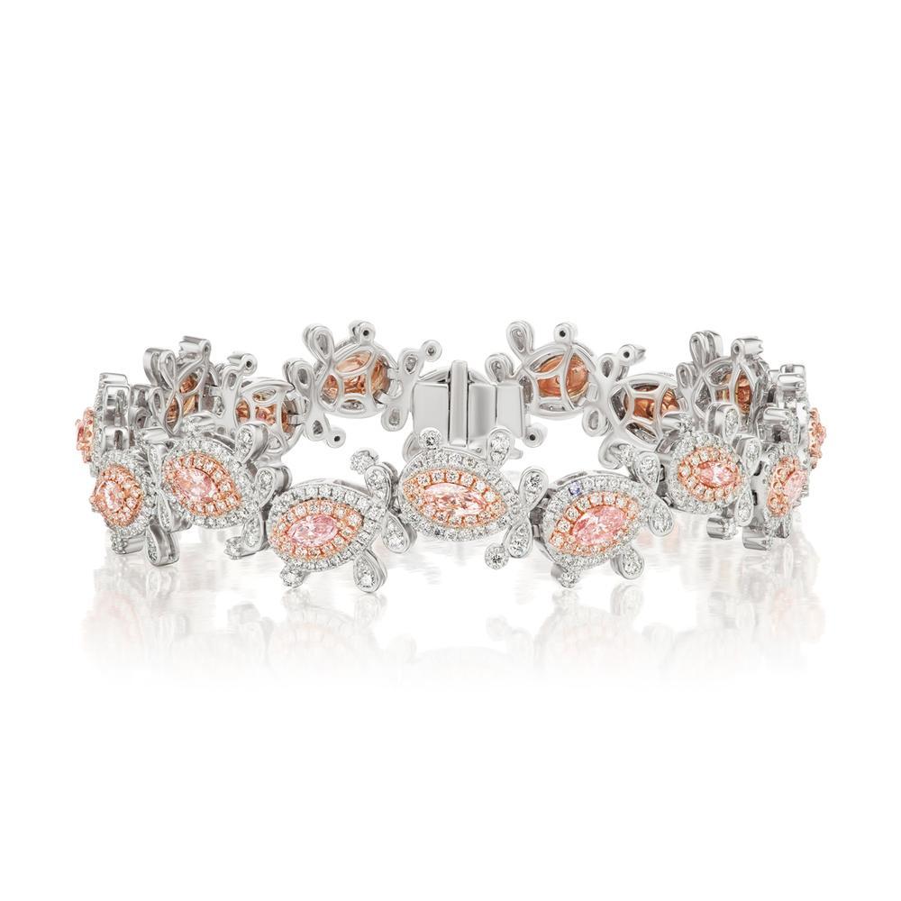 18k White Gold 5.64ct Pink Diamond Bracelet

Crafted with perfection, these white diamonds were carefully placed
around an array of these marquise shaped GIA certified pink diamonds
Item: # 04123
Metal: 18k W / P
Lab: Gia
Diamond Weight: 5.64 ct.
