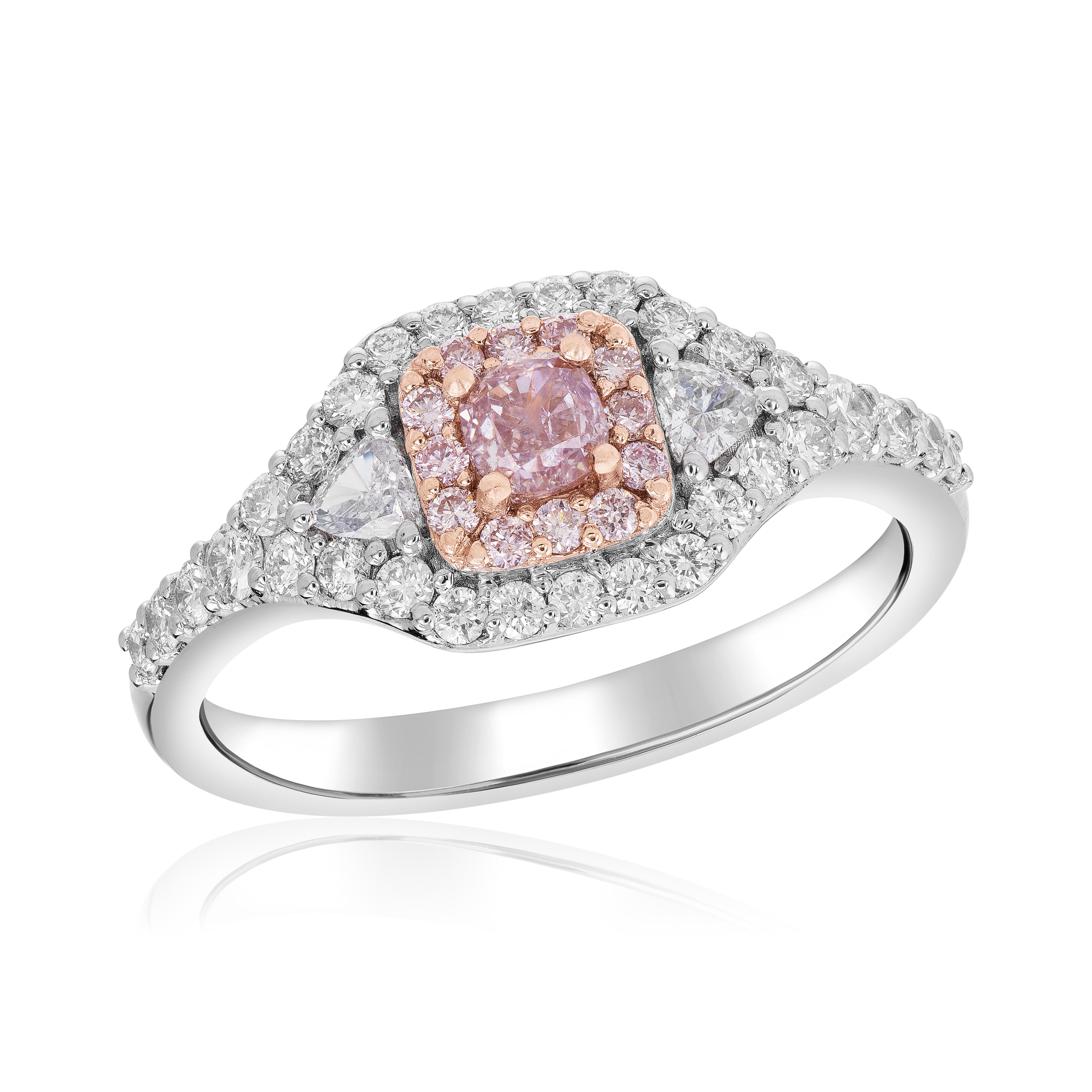 Make a statement with this stunning blush pink diamond ring that exudes elegance and charm. The centerpiece of this ring is a mesmerizing .27 carat cushion-cut pink diamond, captivating the beholder with its delicate and romantic hue. Complementing