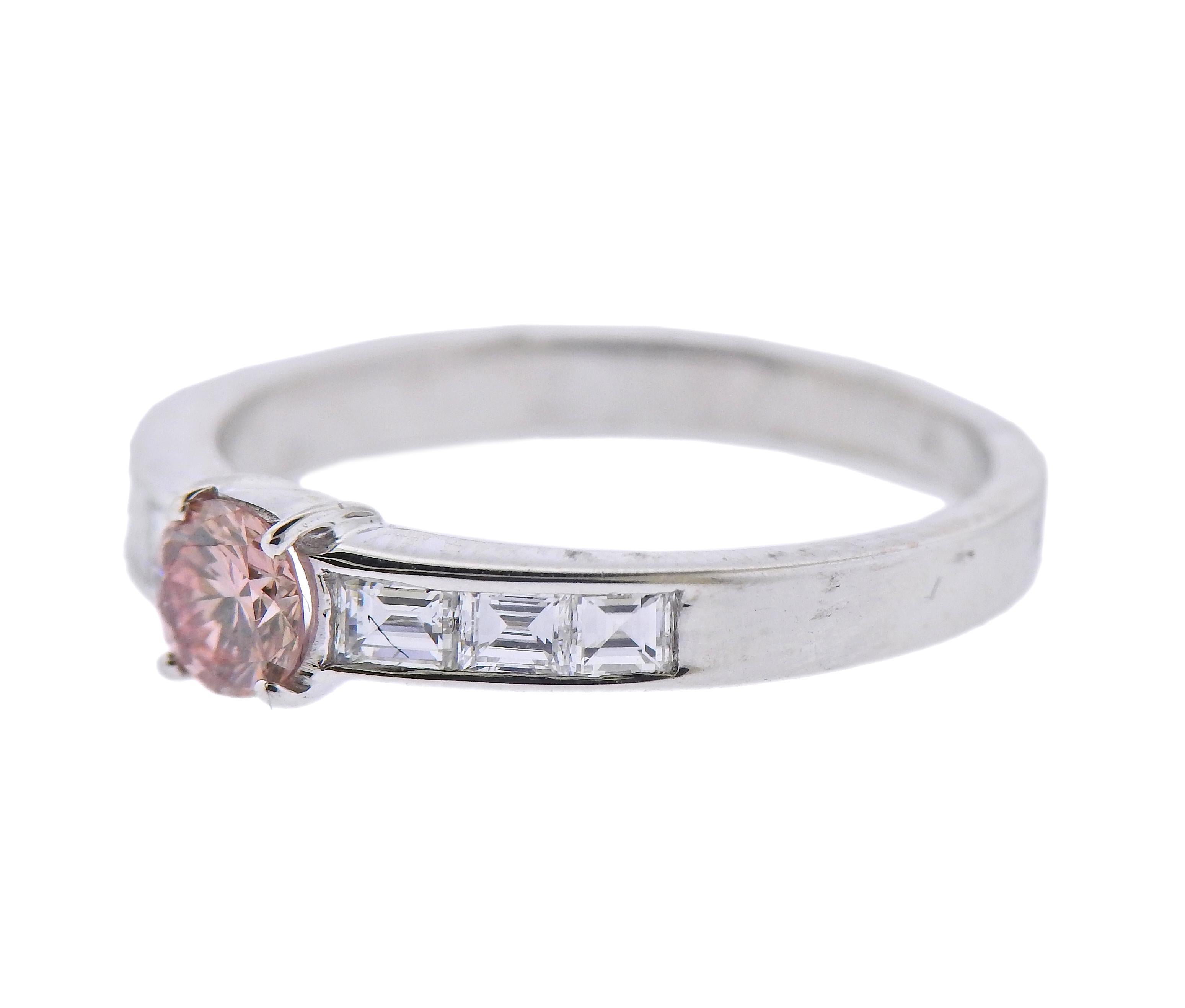 18k white gold engagement ring, with center 0.35ct pinkish/brown center diamond and side square cut white diamonds - approx. 0.30cts. Ring size - 6.75. Marked: 750. Weight - 3.1 grams. 