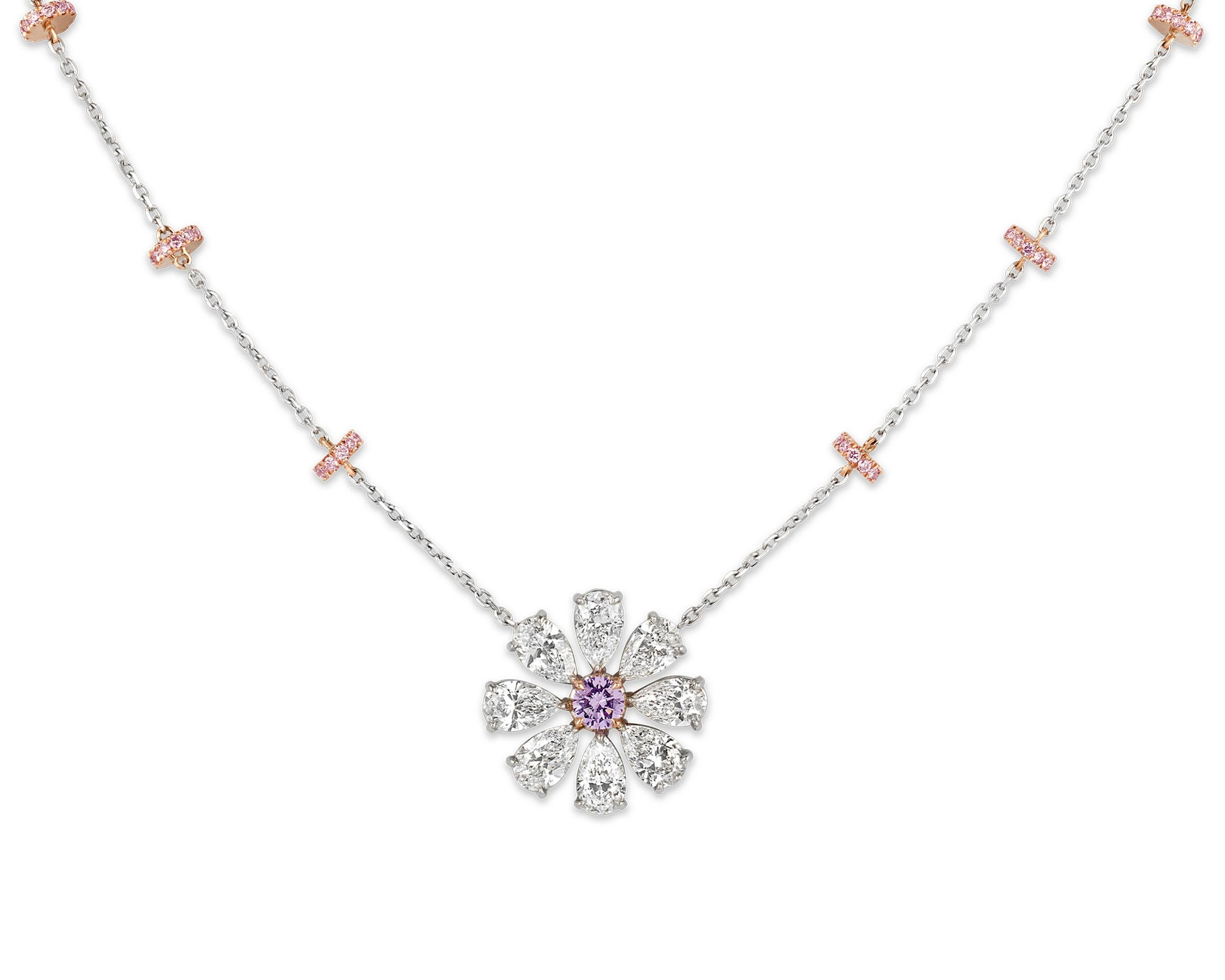 Taking the form of a blossoming flower, this pendant features a 0.28-carat fancy pinkish purple diamond at its center. The remarkable gemstone is certified by the Gemological Institute of America as being all natural, with even color distribution