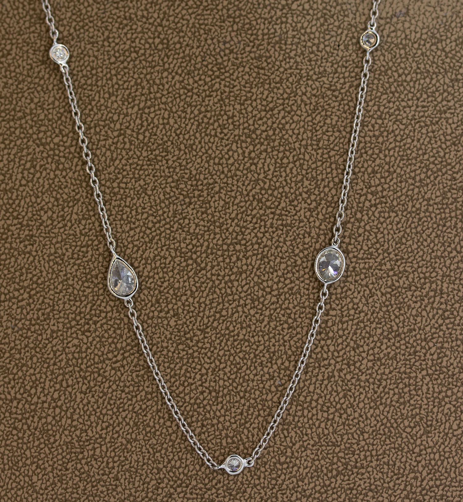 A long ‘diamonds by the yard’ necklace featuring large fancy shaped diamonds. The necklace alternates from smaller round brilliant cut diamonds to larger fancy shapes which include ovals, marquise and pear shaped diamonds. In total they weigh 6.74