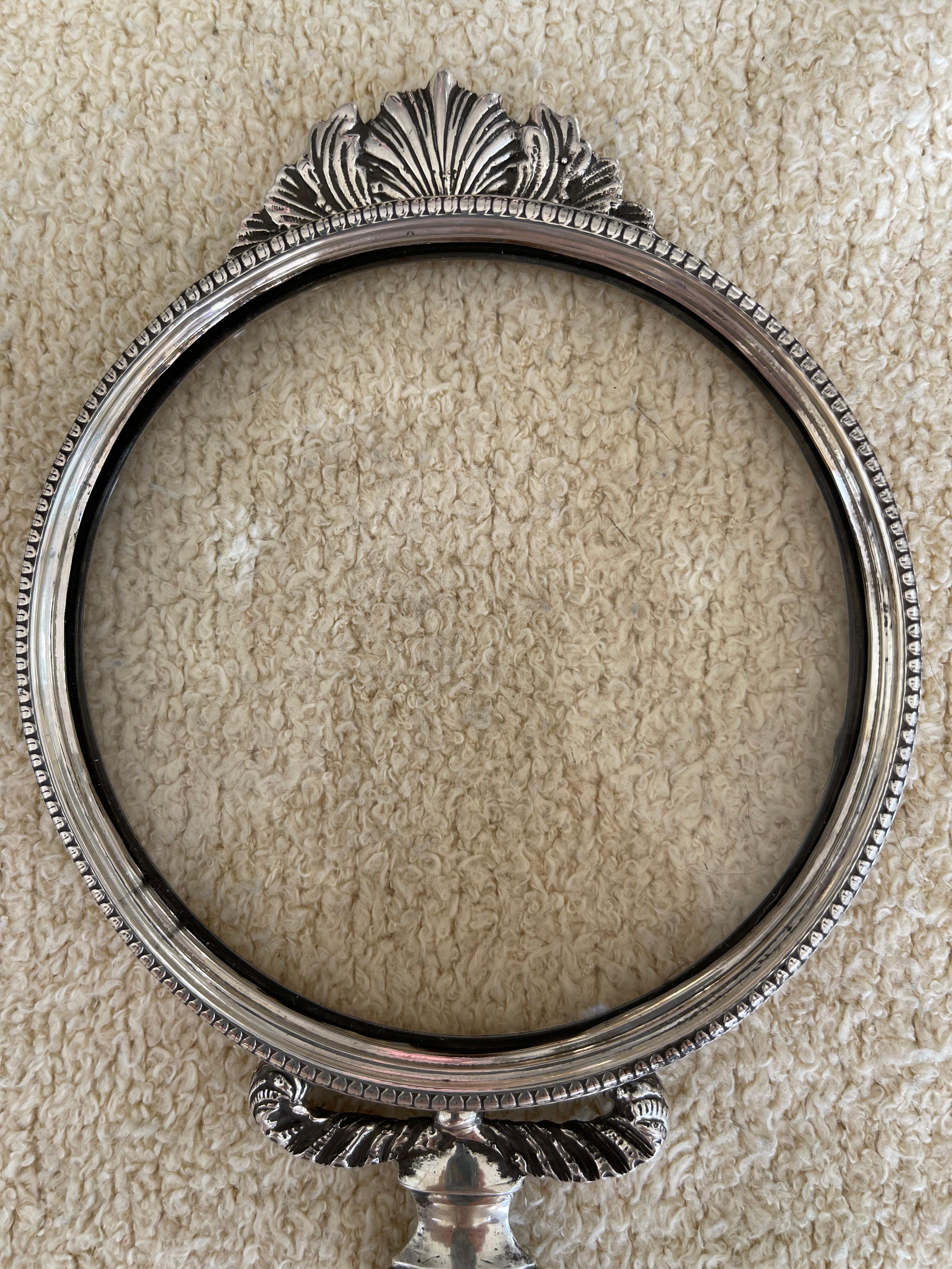  This is magnifying glass is about the highest quality example you can find. Silver plate over bronze and displaying beautiful cast elements. The crest, the handle, and down to the beautifully detailed sides show top quality workmanship. Just to top