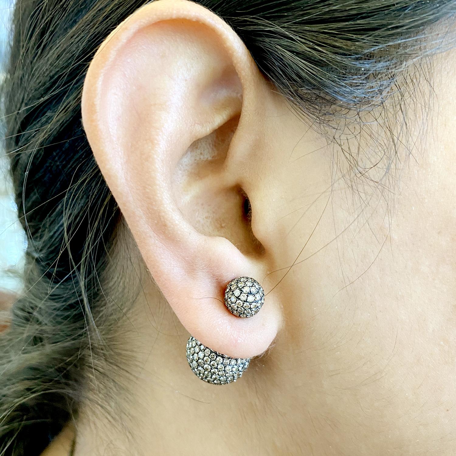 This Fancy Sparkly Brown pave diamond tribal ball earring in 14K black rhodium gold is just a rocking earring.

Pave Ball Size: 8-14mm

Closure: Push

14kt: 12.08gms
Diamond: 8.1cts