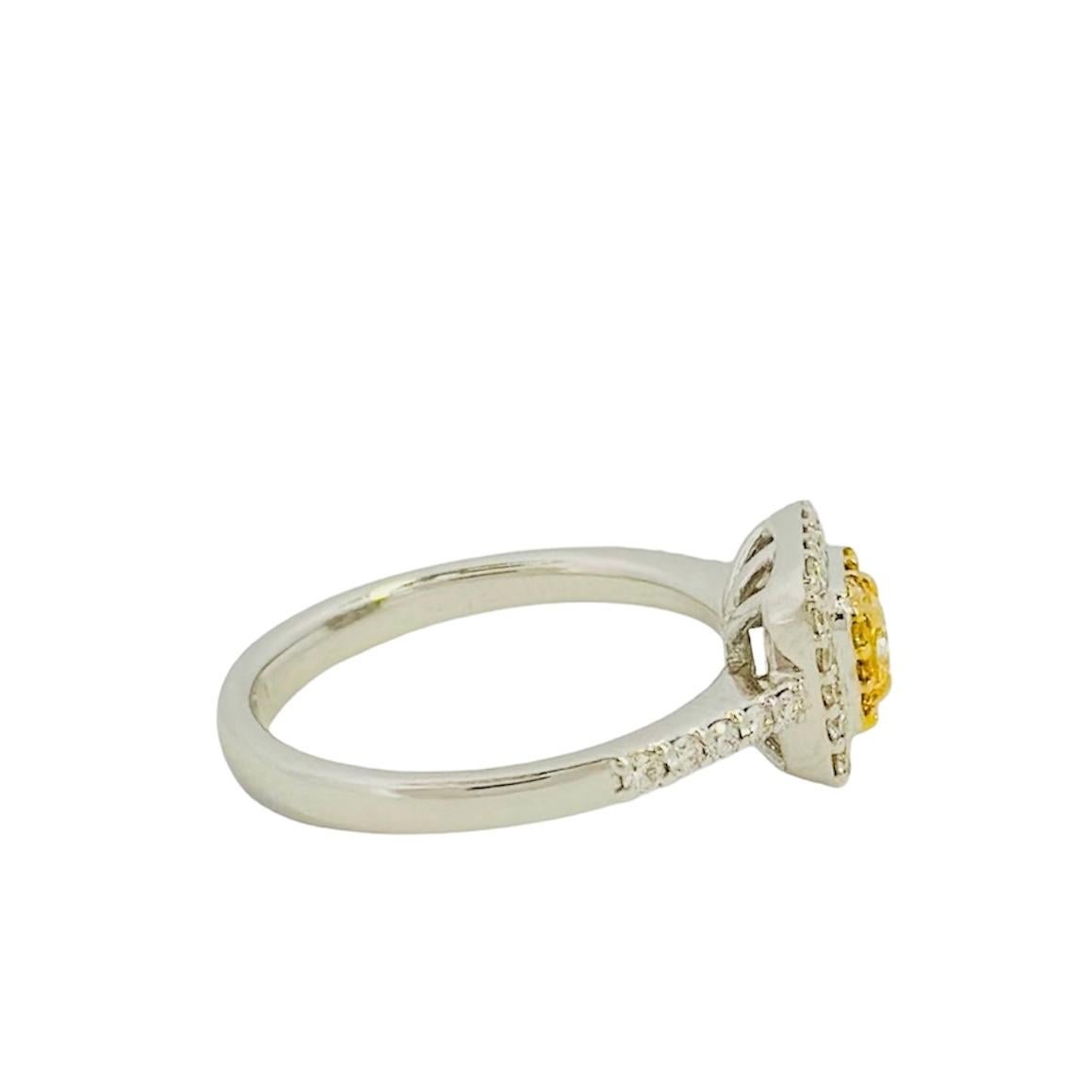 Presenting our Yellow Square-Shaped Cushion Diamond Ring, the epitome of opulence and refinement. This extraordinary piece showcases a stunning 0.26-carat fancy squared-shaped yellow diamond at its center, renowned for its brilliant radiance and