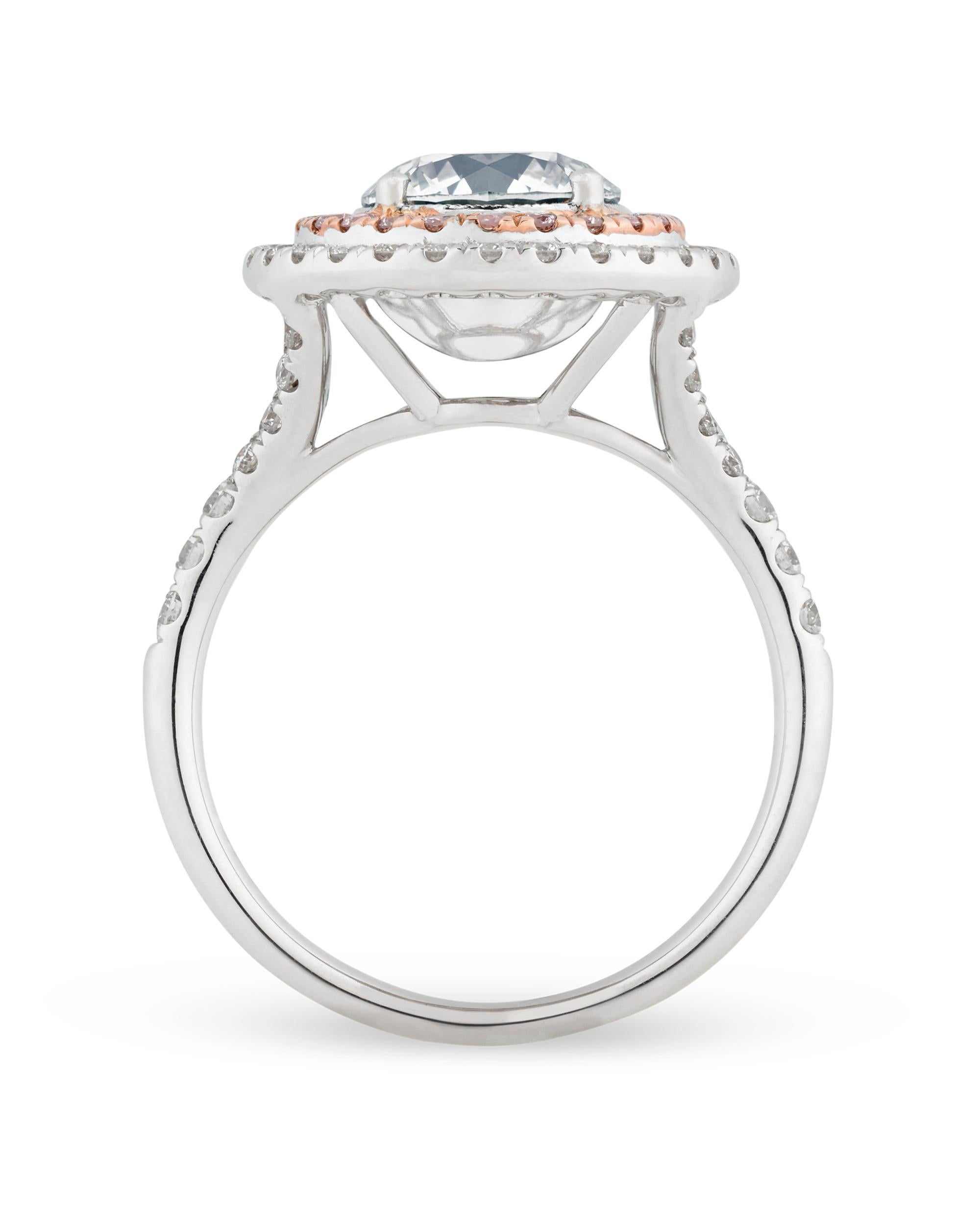 An extraordinary fancy very light grey diamond displays incredible depth in this captivating ring. This rare 1.73-carat gem exhibits a cool, steel grey hue, with a fiery spark that is enhanced by the rosy pink diamonds that surround it. Certified by