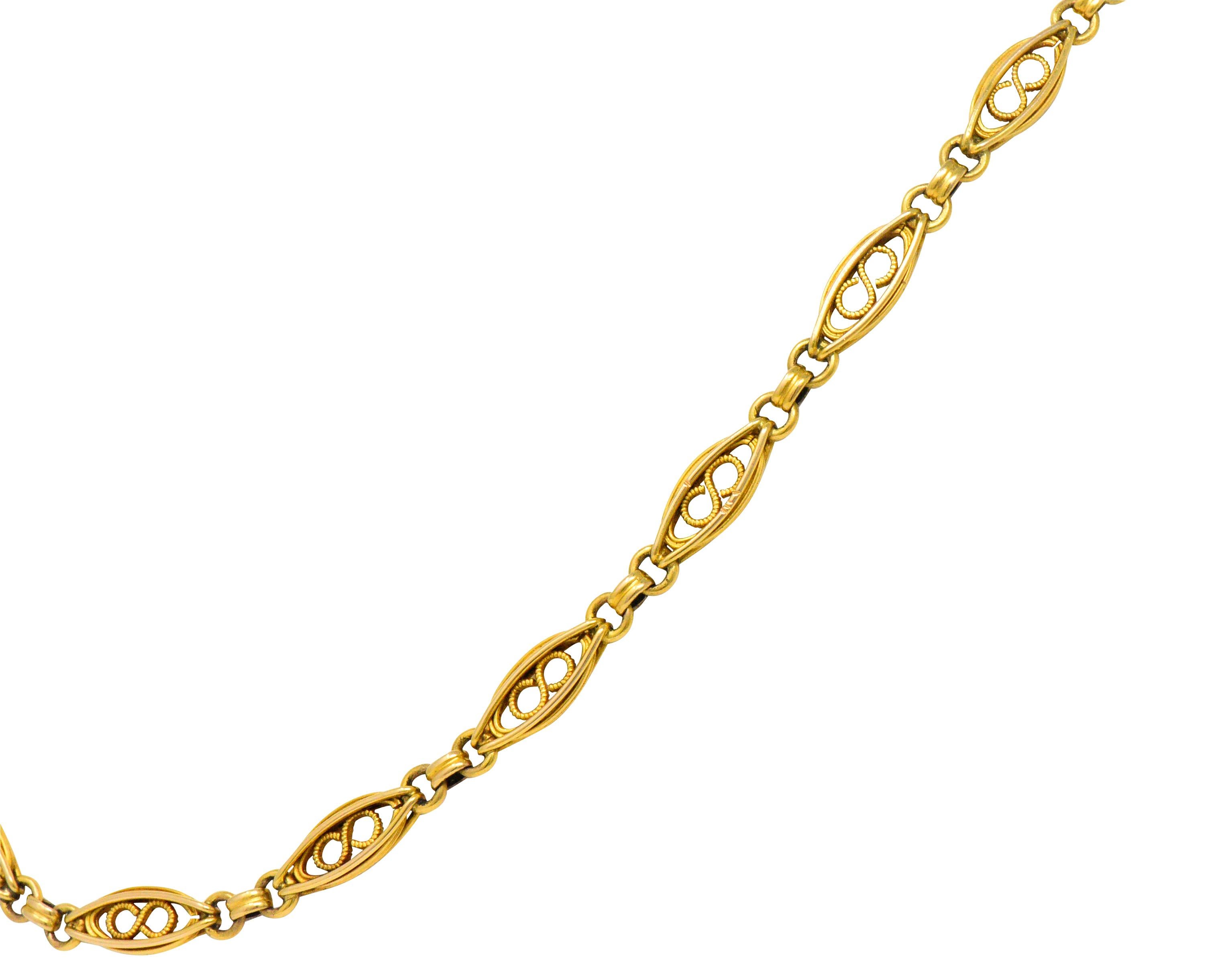Link style necklace comprised of elongated links that center a twisted gold infinity motif

Alternating with ribbed gold spacer links

Completed by a spring ring clasp 

Length: Approx. 17 1/2 inches

Width at widest: 1/4 inch 

Total Weight: 23.0