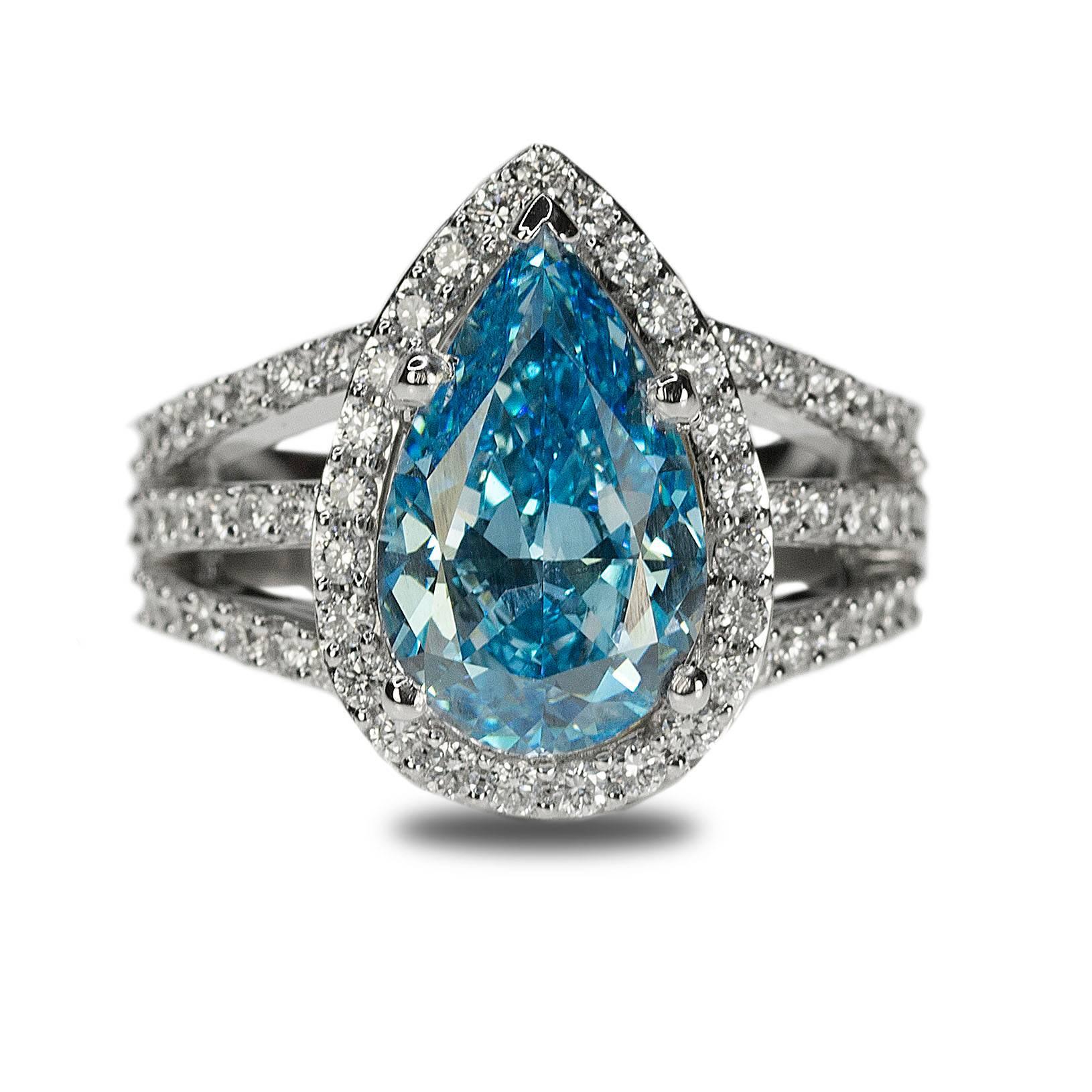 18k Ring with one GIA cetified HPHT Fancy Vivid Blue, VVS1 clarity diamonds weighing 4.02 carats and 0.96 carats of fine white natural diamonds.