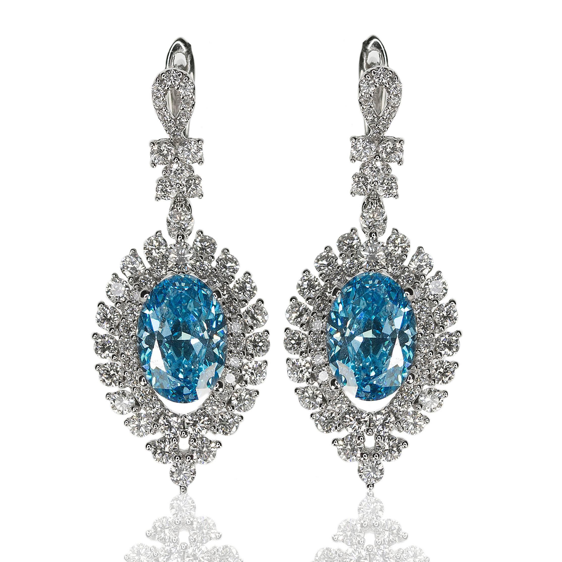 18k Earrings with two GIA certified HPHT Fancy Vivid Blue, VVS1 clarity diamonds weighing 4.12 carats and 1.12 carats of fine white natural diamonds.