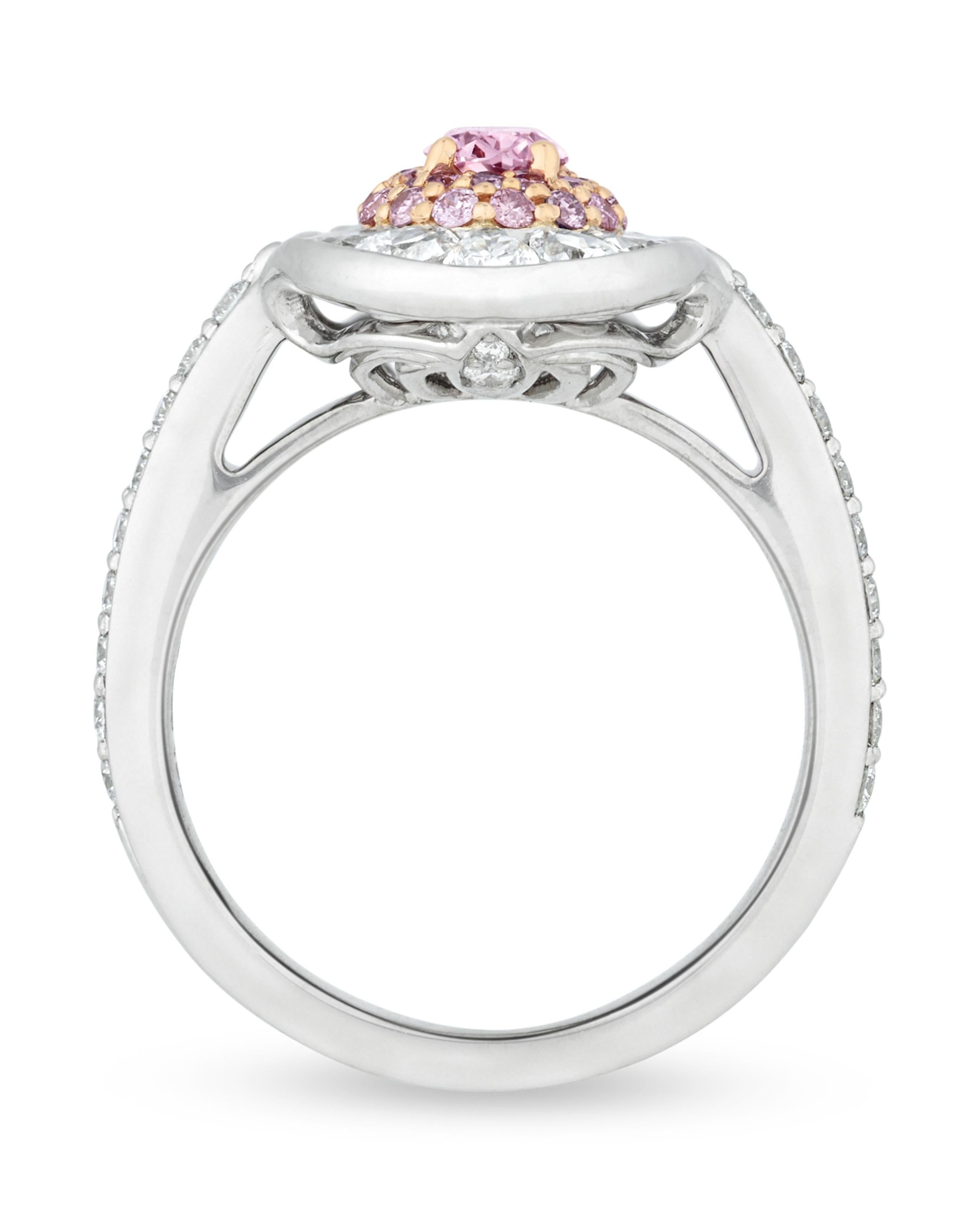 One of nature’s rarest treasures, the 0.32-carat natural fancy vivid pink diamond at the center of this ring displays a romantic pink hue. While pink diamonds come in an array of hues and tones, the very best are graded “fancy vivid” and display the