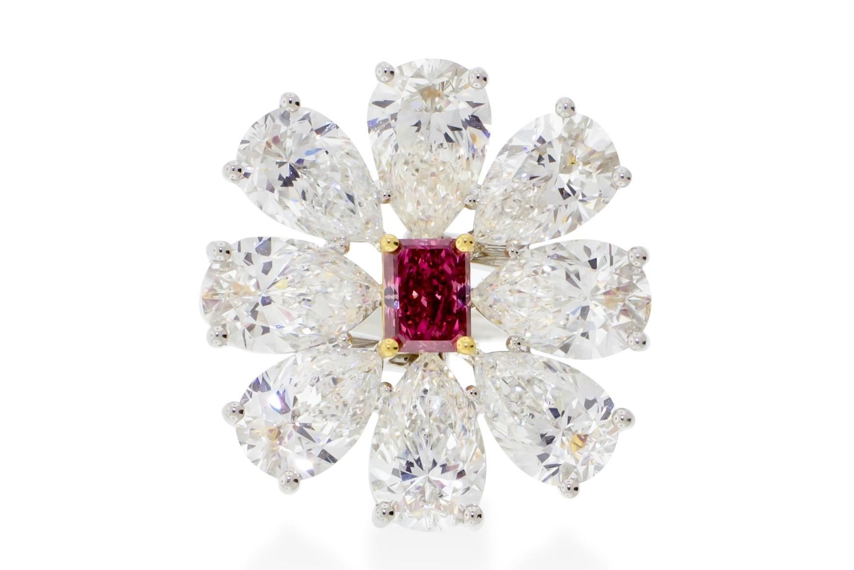 A 0.44 carat fancy vivid pink radiant cut center stone set in 18K yellow gold surrounded by 8 pear shapes diamonds weighing 6.12 carats set in platinum that come together to make a beautiful delicate flower. GIA certified. Report No. 1172177345.