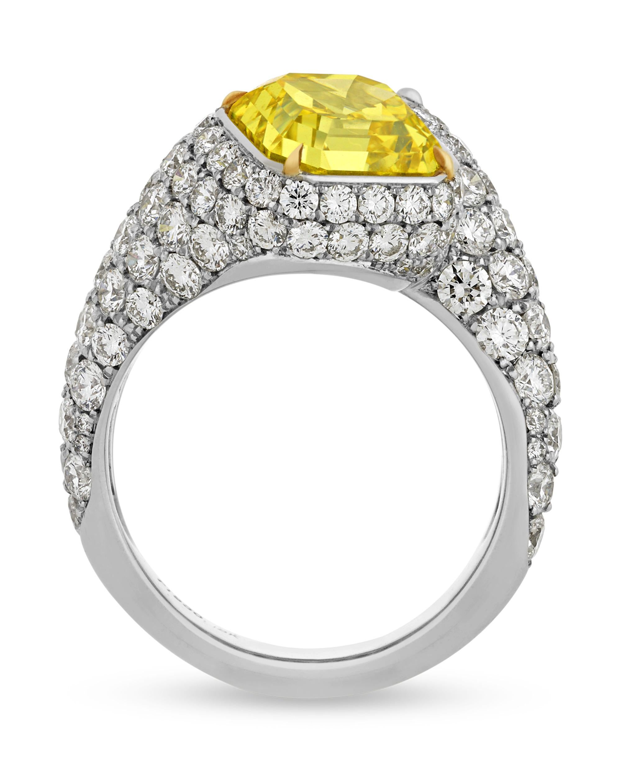 Forming an elegant bypass design, a 3.58-carat yellow diamond and a 3.03-carat white diamond find harmony in this ring. Both emerald-cut stones are certified by the Gemological Institute of America as displaying very good polish and symmetry, and
