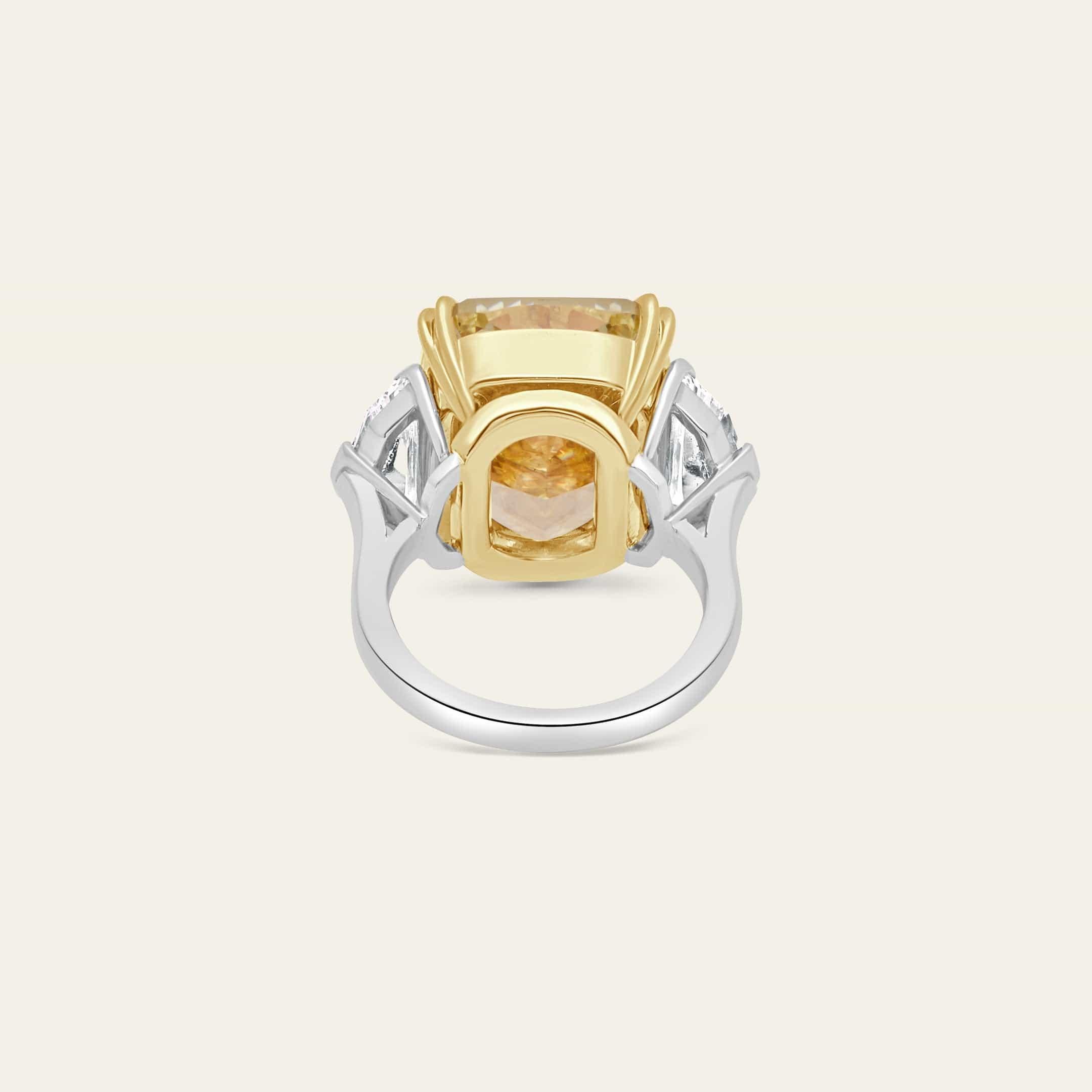 A masterpiece of rare brilliance, this extraordinary ring features a breathtaking 20.22 carat GIA-certified Fancy Intense Yellow diamond, radiating warmth and unparalleled vibrance. Set in a striking combination of platinum and 18K yellow gold, the