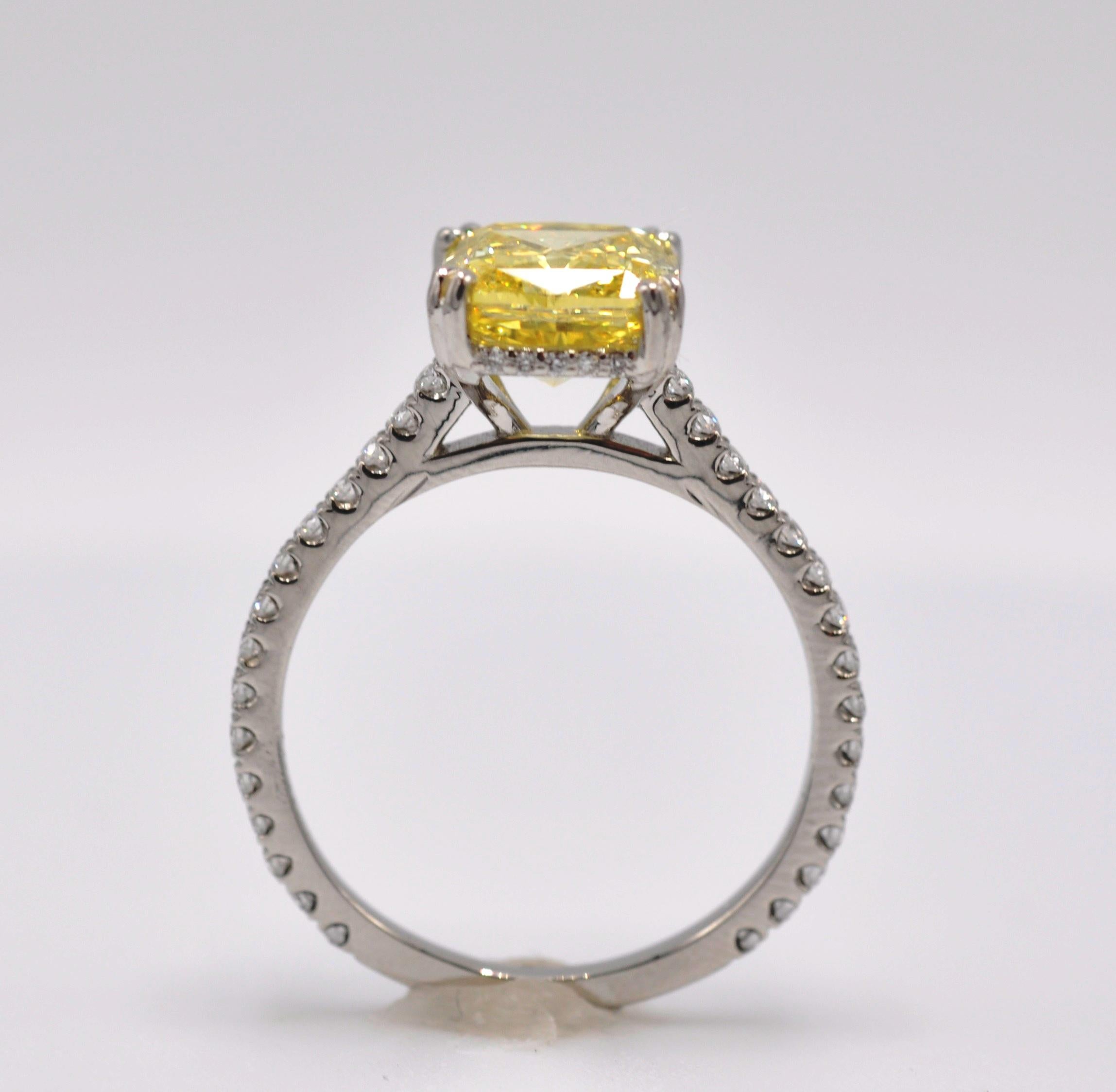 3.02ctw Fancy Vivid Yellow Diamond Platinum Engagement Ring. GIA certified center stone.  3.02 CTW Center Stone set in Platinum and Diamond Setting  which extends 3V4 way around the ring.   Brand New, never worn.  Size 7.25 and can be sized to fit. 