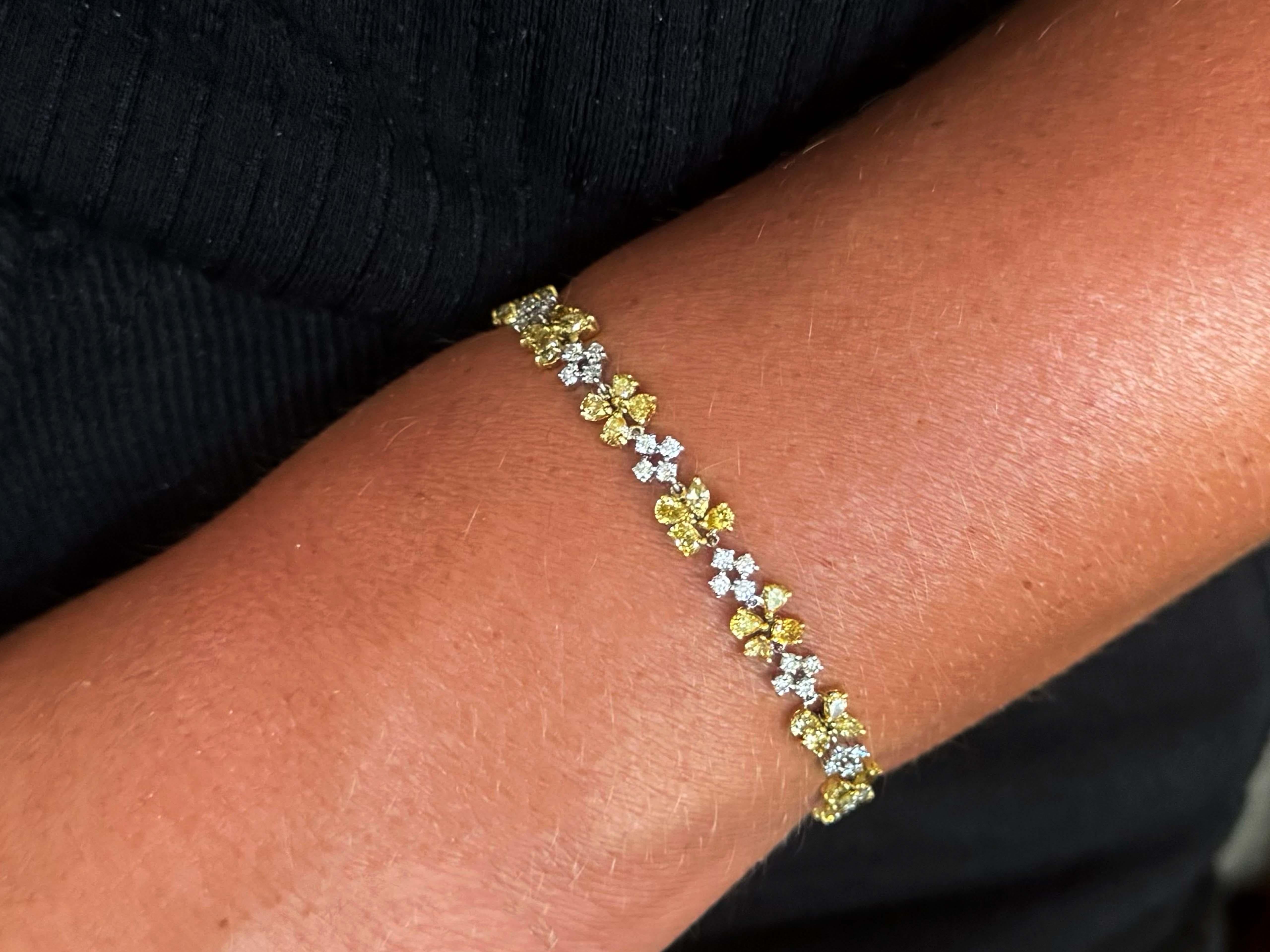 Bracelet Specifications:

Metal: 18k White Gold

White Diamond Count: 56 brilliant cut diamonds

White Diamond Carat Weight: ~1.68

White Diamond Color: G

White Diamond Clarity: VS

Colored Diamond Count: 56 natural fancy yellow diamonds

Colored