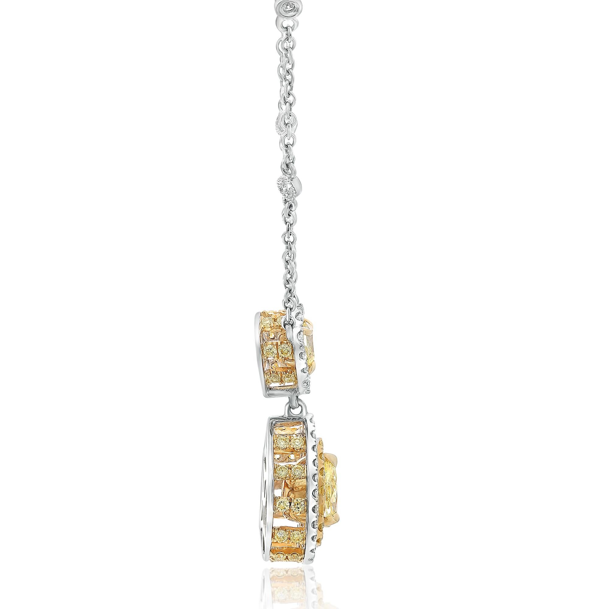 This fabulous pendant necklace features two fancy yellow pear-shaped diamonds as well as accenting diamonds in both white and yellow. It is crafted from 18 karat white and yellow gold. 

2 Fancy Yellow Pear-shaped diamonds = 1.02 carats total