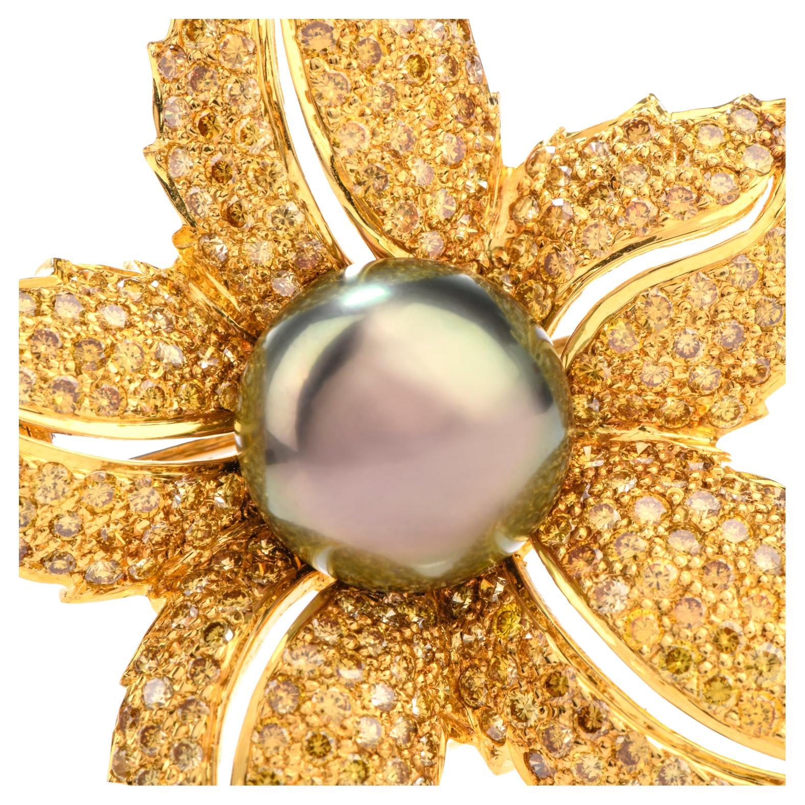This incredibly bright and glistening brooch was inspired by a

tropical floral motif and crafted in 18K yellow gold.

Measuring appx. 1.5 x 2.0 inch, the brooch is certain

to make a statement.  Featuring one 12mm Tahitian pearl in the center,