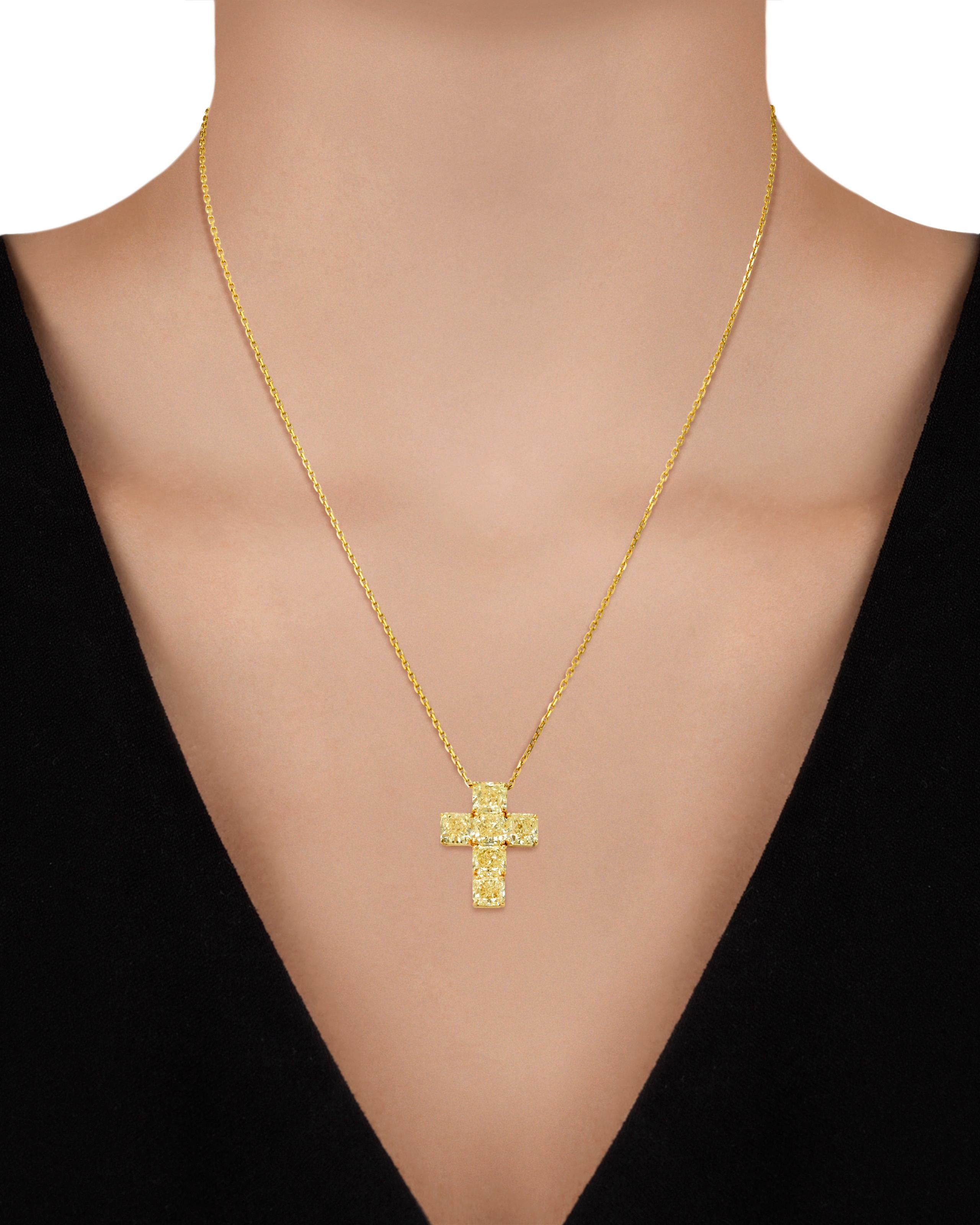 This timeless diamond necklace is a lesson in symmetry and harmony. Dazzling radiant-cut fancy yellow diamonds weighing approximately 6.42 total carats adorn the bold, yet elegant cross design. Each brilliant stone is GIA certified as natural fancy