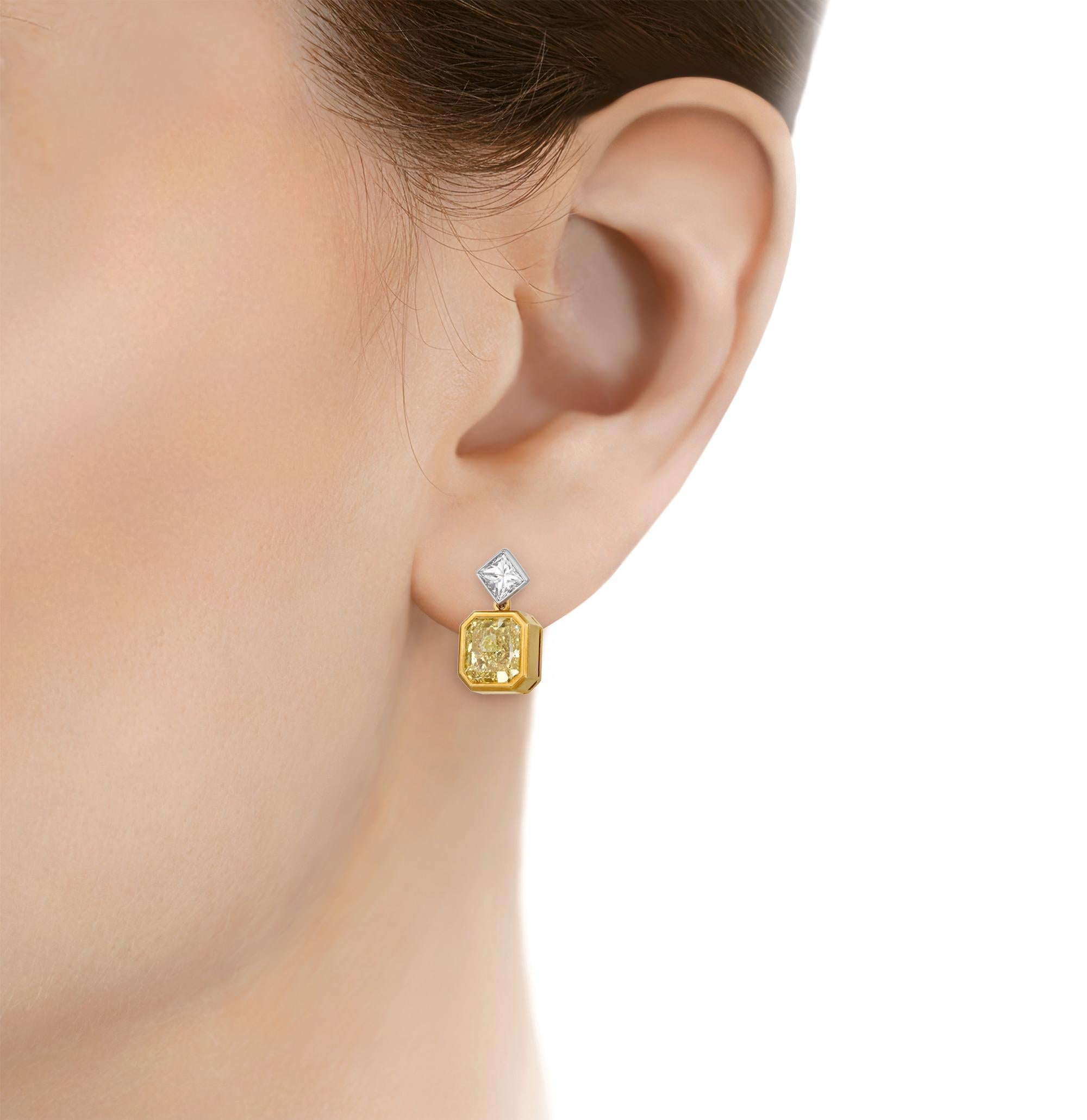 This exquisite pair of dangle earrings features two fancy yellow diamonds with VVS1-VVS2 clarity totaling 4.47 carats. Their radiant cut shines in a refined 18K yellow gold bezel setting. The sun-brilliant hue of the yellow diamonds is perfectly