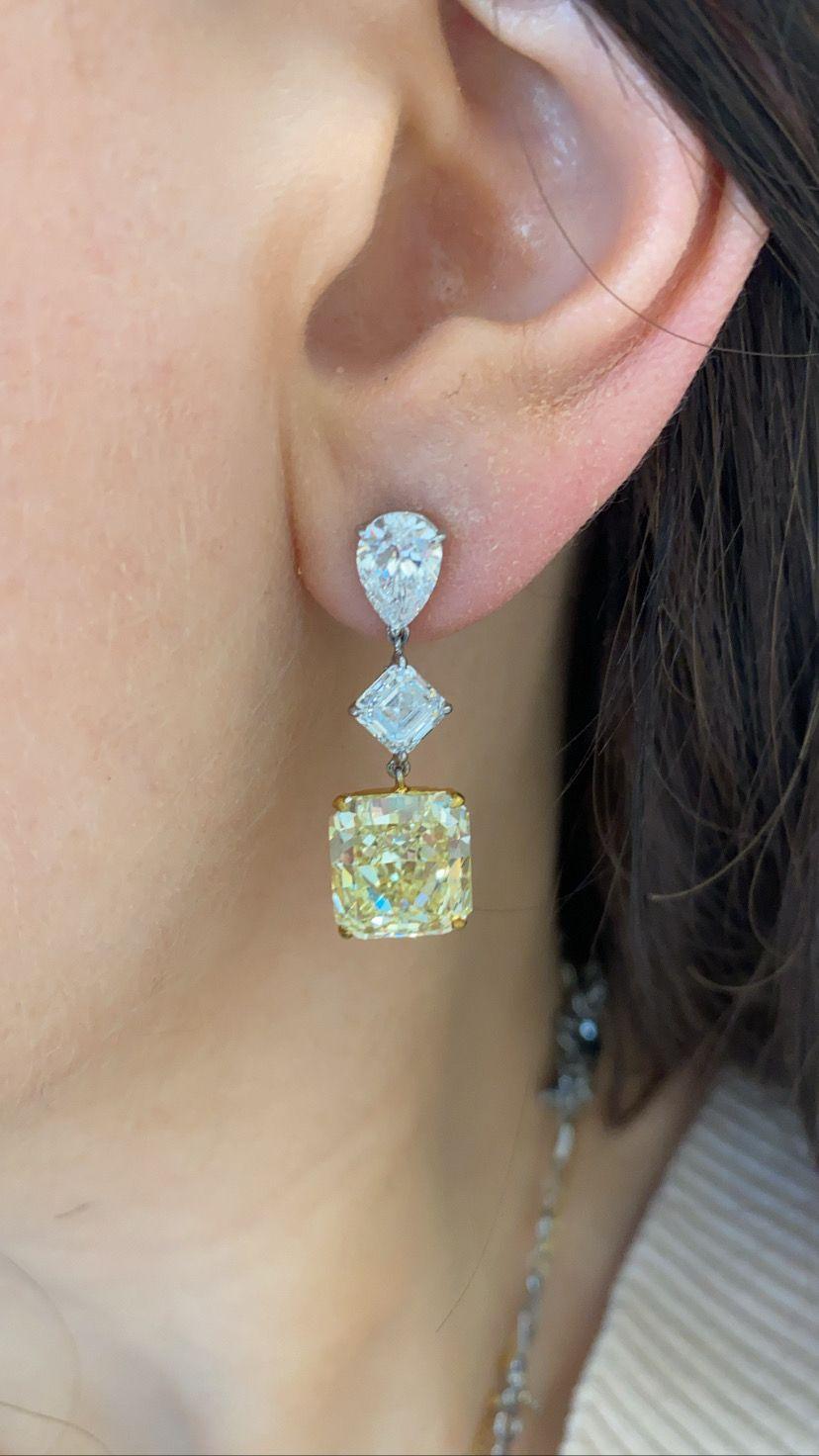 Matching pair of radiant shape fancy yellow diamond Earrings
The fancy yellow radiant diamonds are 12.42 ctw.
Accompanied by GIA Lab Colored Diamond Reports.
Each yellow diamond suspends from a 1.00 carat asscher cut diamond wit a pear shaped stud