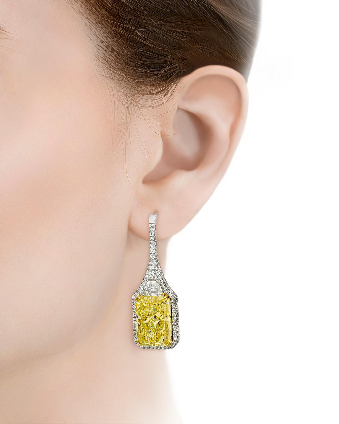 Two expertly matched radiant cut fancy yellow diamonds shine brilliantly in these elegant drop earrings. These diamonds display a lovely even color and are GIA certified as natural fancy yellow, weighing 5.62 and 4.58 carats respectively and