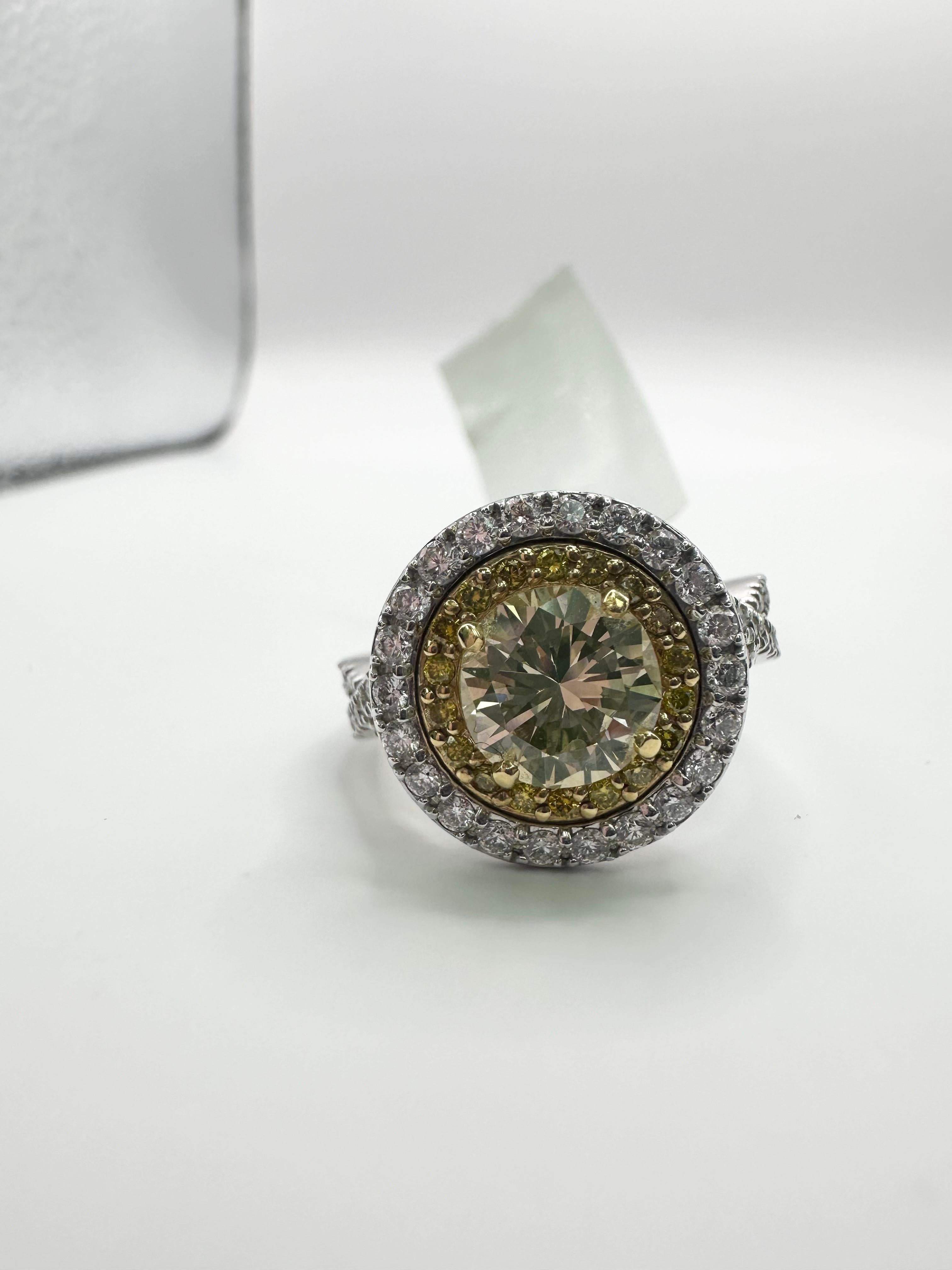 Stunning fancy yellow diamond ring in 18KT gold, the center stone is so beautiful round brilliant accompanied by a halo of yellow diamonds and another layer of white. Made with quality in mind and will last generations to come! 

1.41ct center