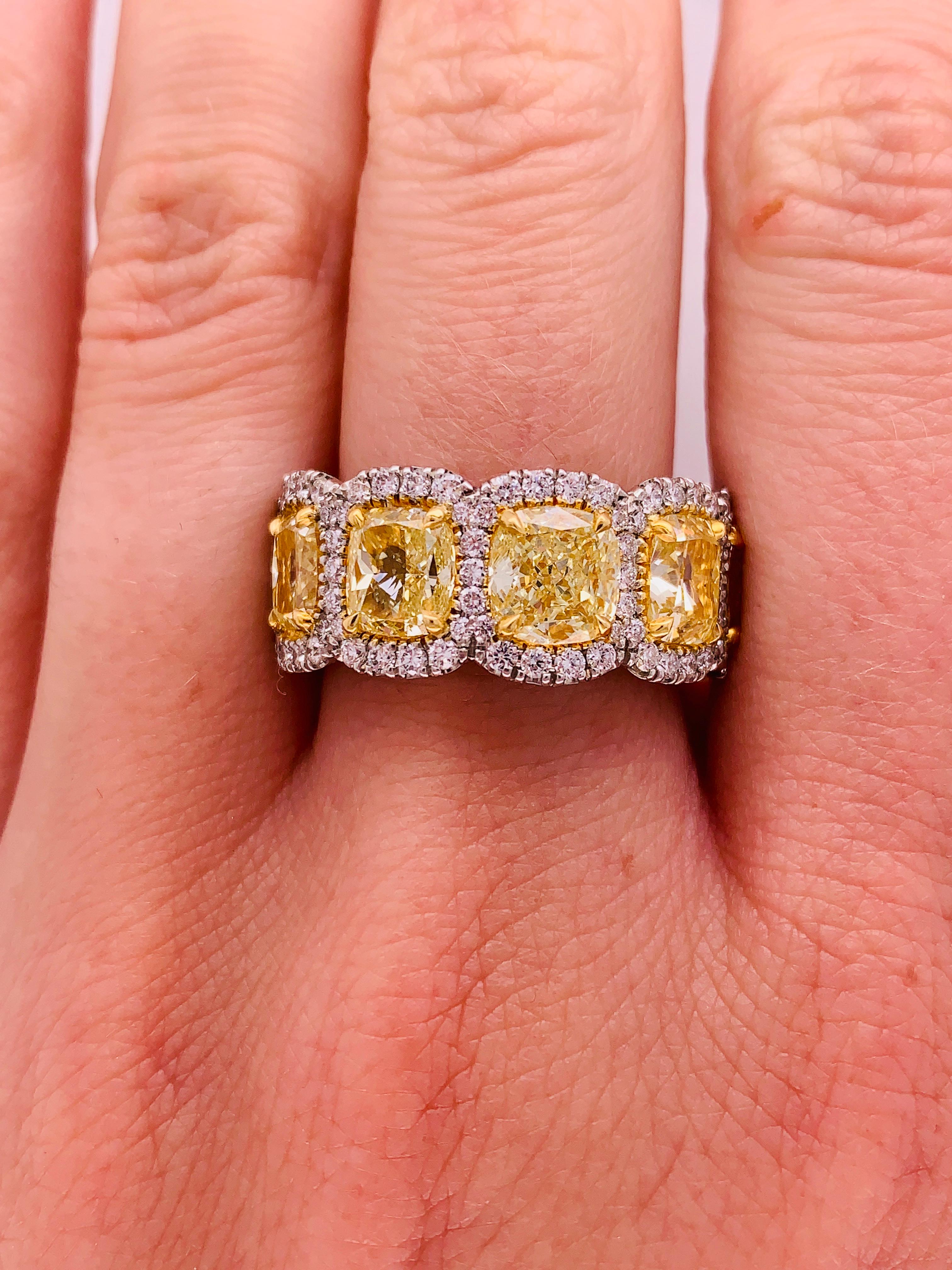 Magnificent Fancy Yellow diamond diamond band, features 5.50 Carats of Fancy color Yellow Cushion Cut Diamonds, surrounded by 1.20 Carats of white round brilliant cut diamonds. Each stone is approximately 1.00 carat (plus) cushion cut. Each stone