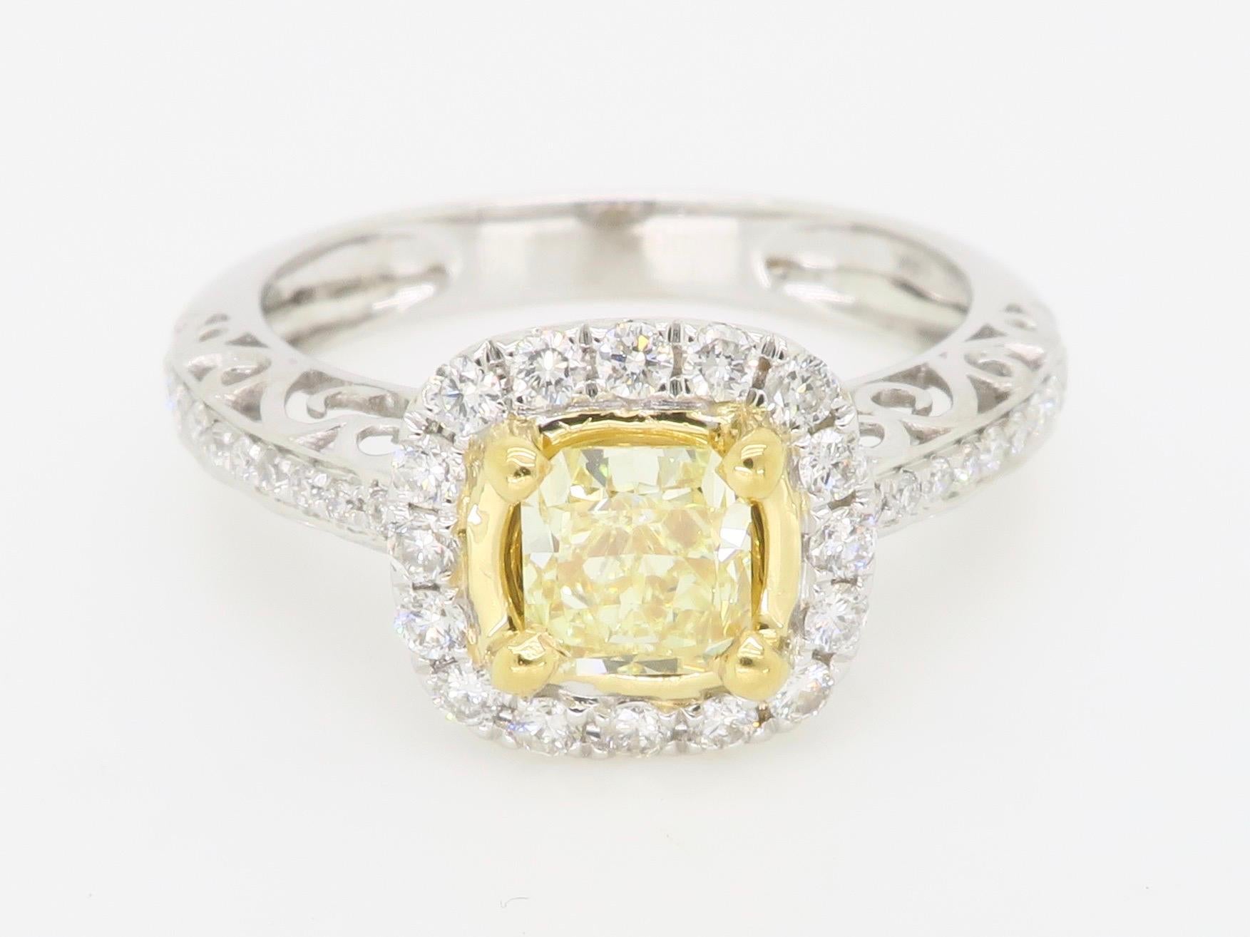 Stunning Yellow Diamond set into a halo diamond ring crafted in 18k White Gold. 

Center Diamond Carat Weight: Approximately .58CT
Center Diamond Cut: Cushion Cut
Center Diamond Color: Fancy Yellow    
Center Diamond Clarity: S11
Total Diamond Carat