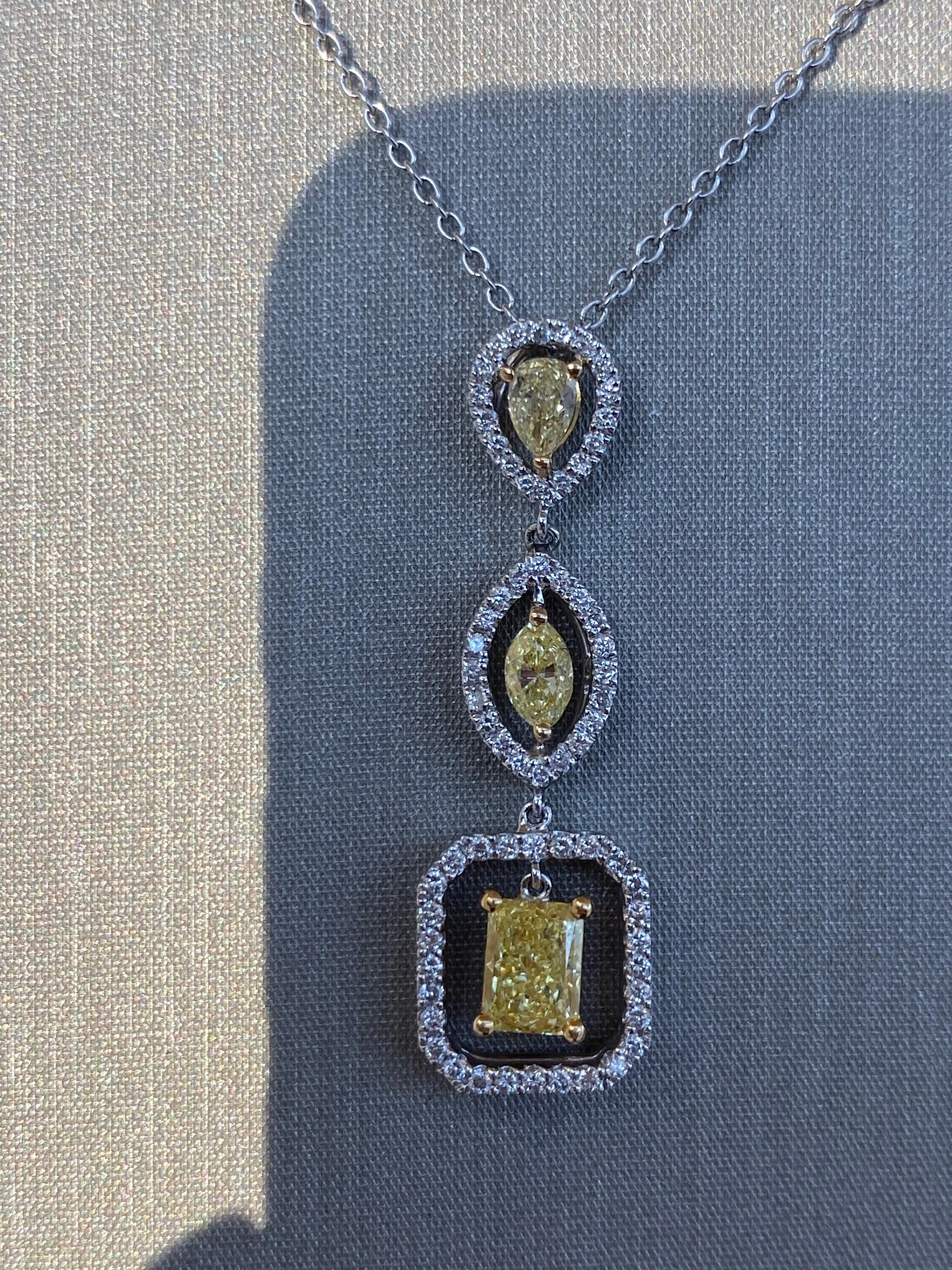 Fancy Yellow Diamond Pendant Necklace.  This beautiful one of a kind drop necklace has three Fancy Yellow Diamonds dangling in-between halos of brilliant round cut white diamonds.  What I love about this pendant is that it is simple enough to be