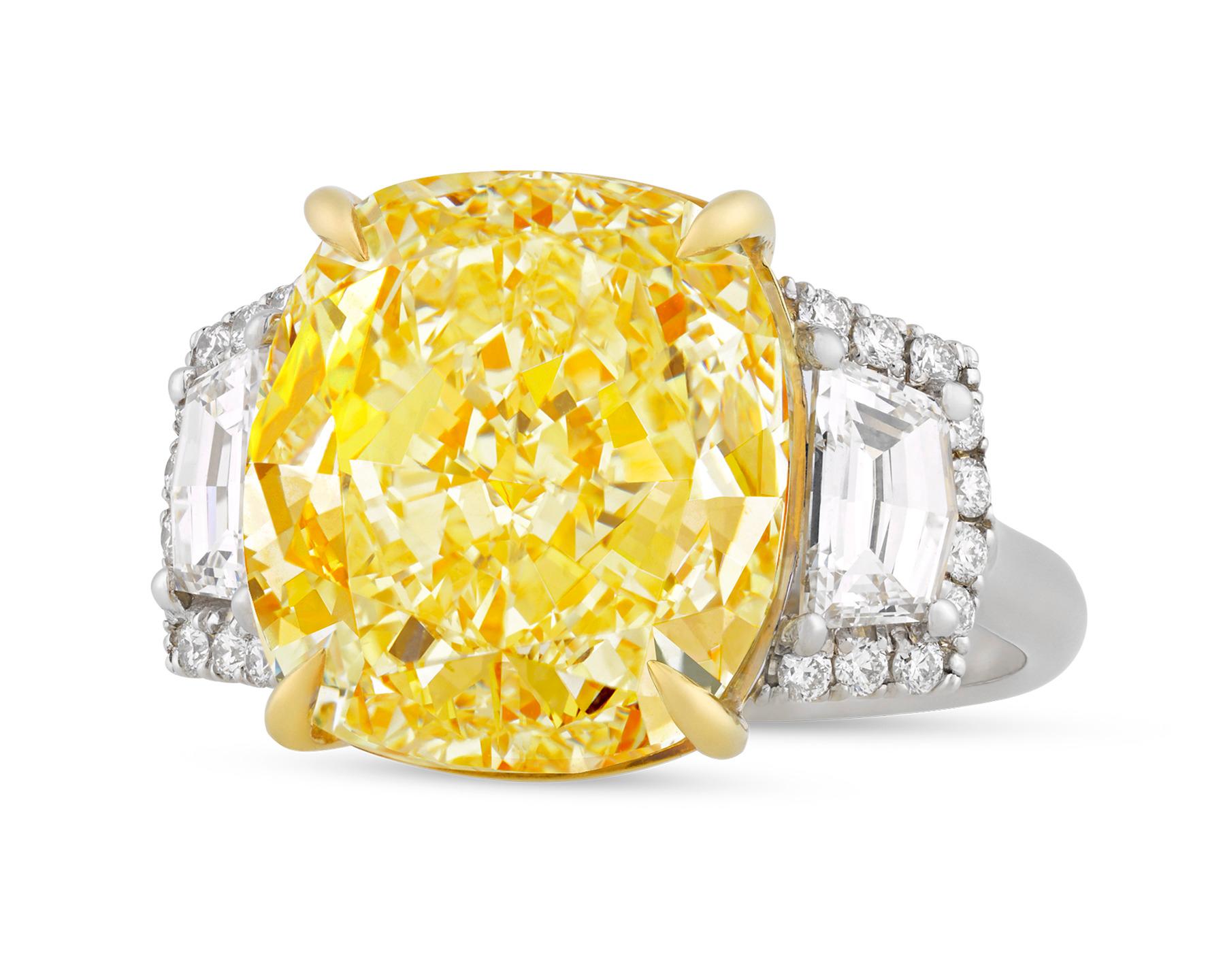 A truly exceptional 11.00-carat fancy yellow diamond is the star of this eye-catching ring. The cushion-cut gemstone is certified by the Gemological Institute of America as 