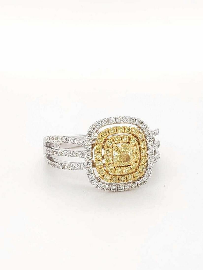 Fancy Yellow Diamond Ring 18 Karat White Gold with 86 Diamonds 0.52 total carat.  This is has a split band with 3 rows of diamonds down each side and making it really stand out.

Featuring prong set cushion cut fancy yellow gold center stone