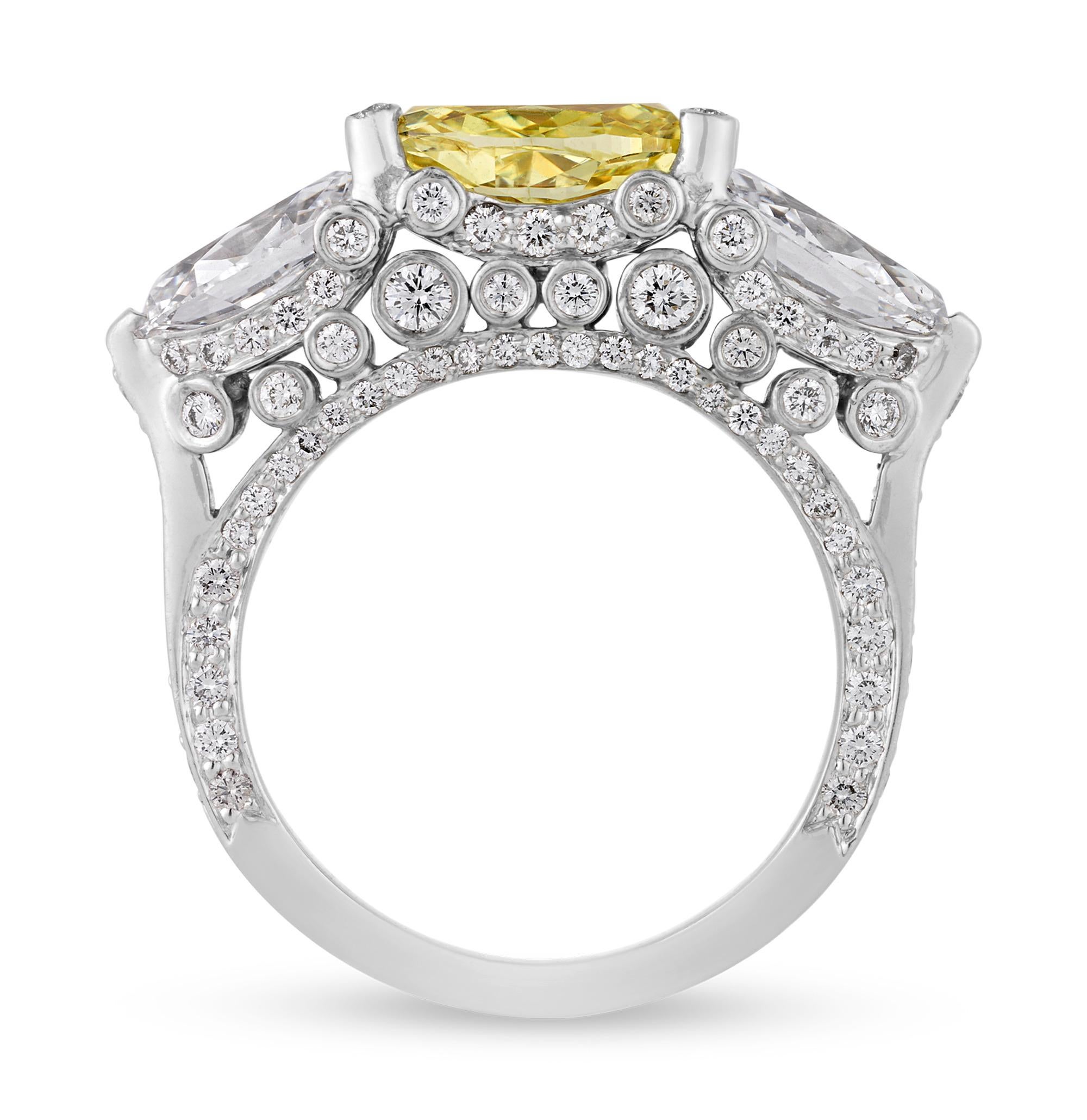 This exquisite fancy yellow diamond ring perfectly embodies sophistication and timeless elegance. At its heart lies a breathtaking GIA-certified fancy yellow oval-cut diamond, weighing 1.81 carats. The yellow diamond is certified by the Gemological
